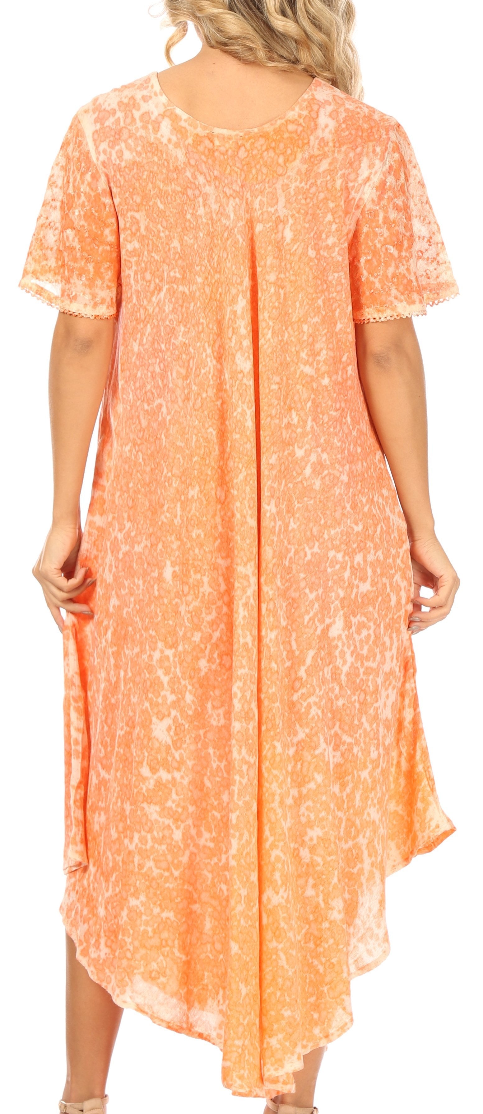 Woman wearing a peach-colored dress with a floral pattern.