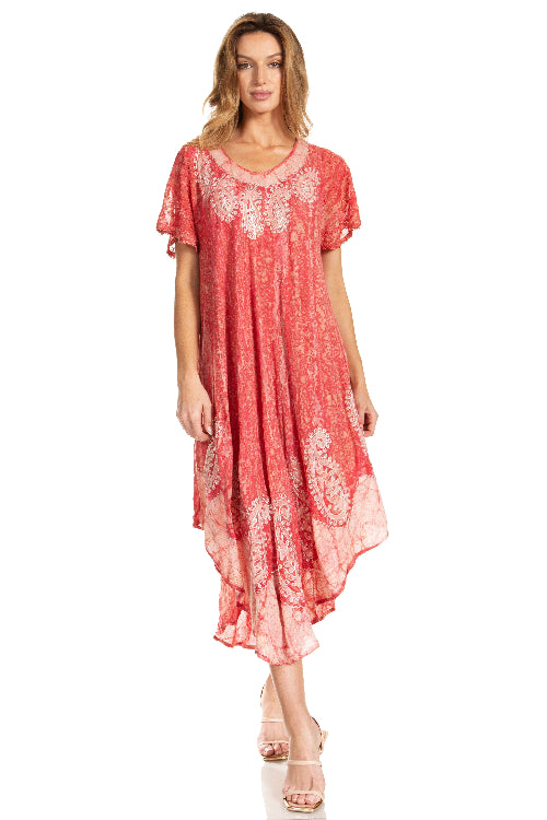 Woman wearing a coral dress with white lace details on a white background