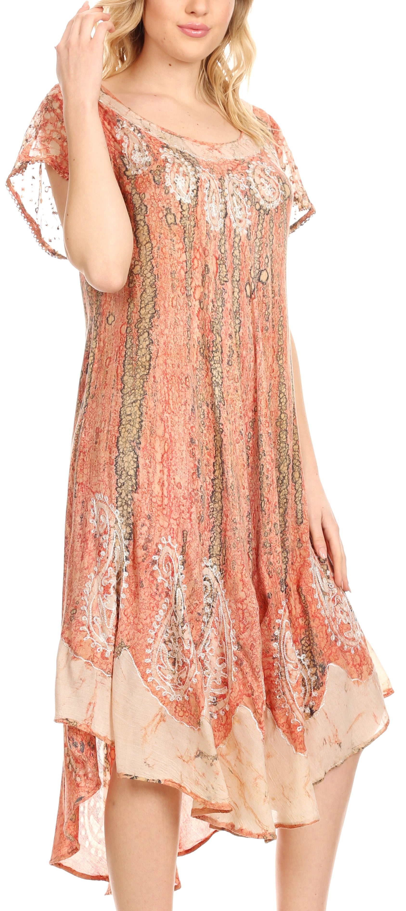 Woman wearing a floral patterned dress with a soft peach color.