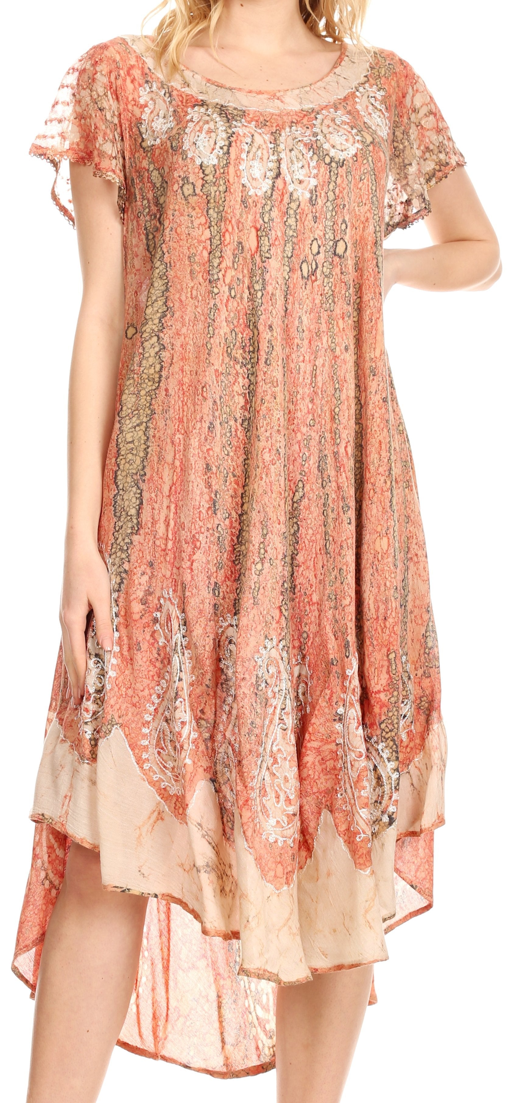 Woman wearing a floral patterned dress with short sleeves and a high-low hem.