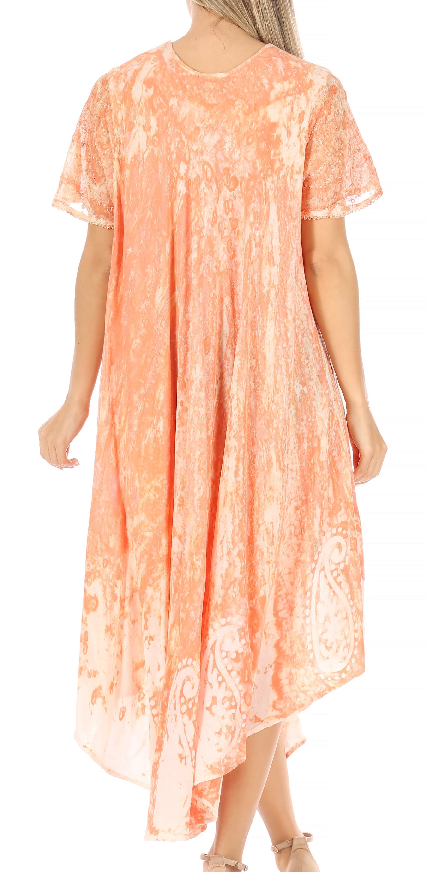 Woman wearing a peach-colored dress with floral pattern on a white background