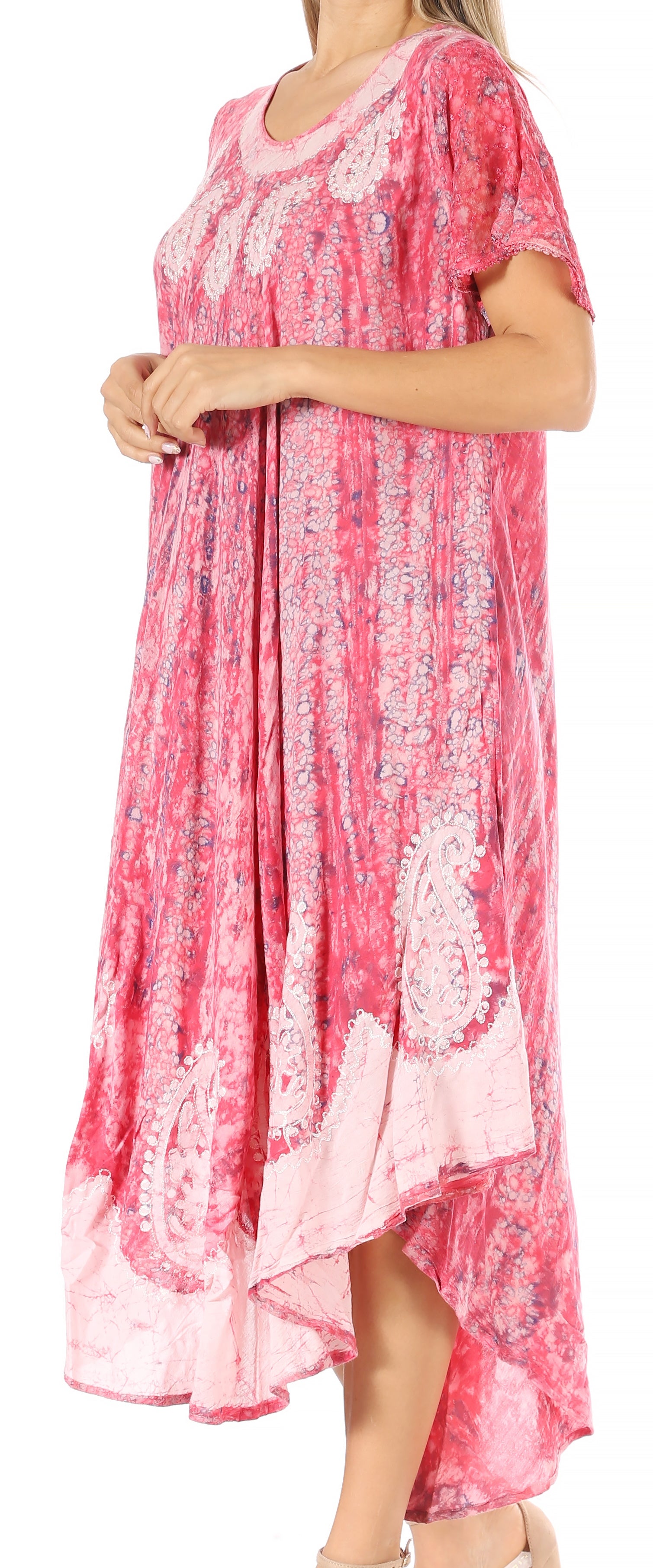 Woman wearing a pink floral dress against a white background