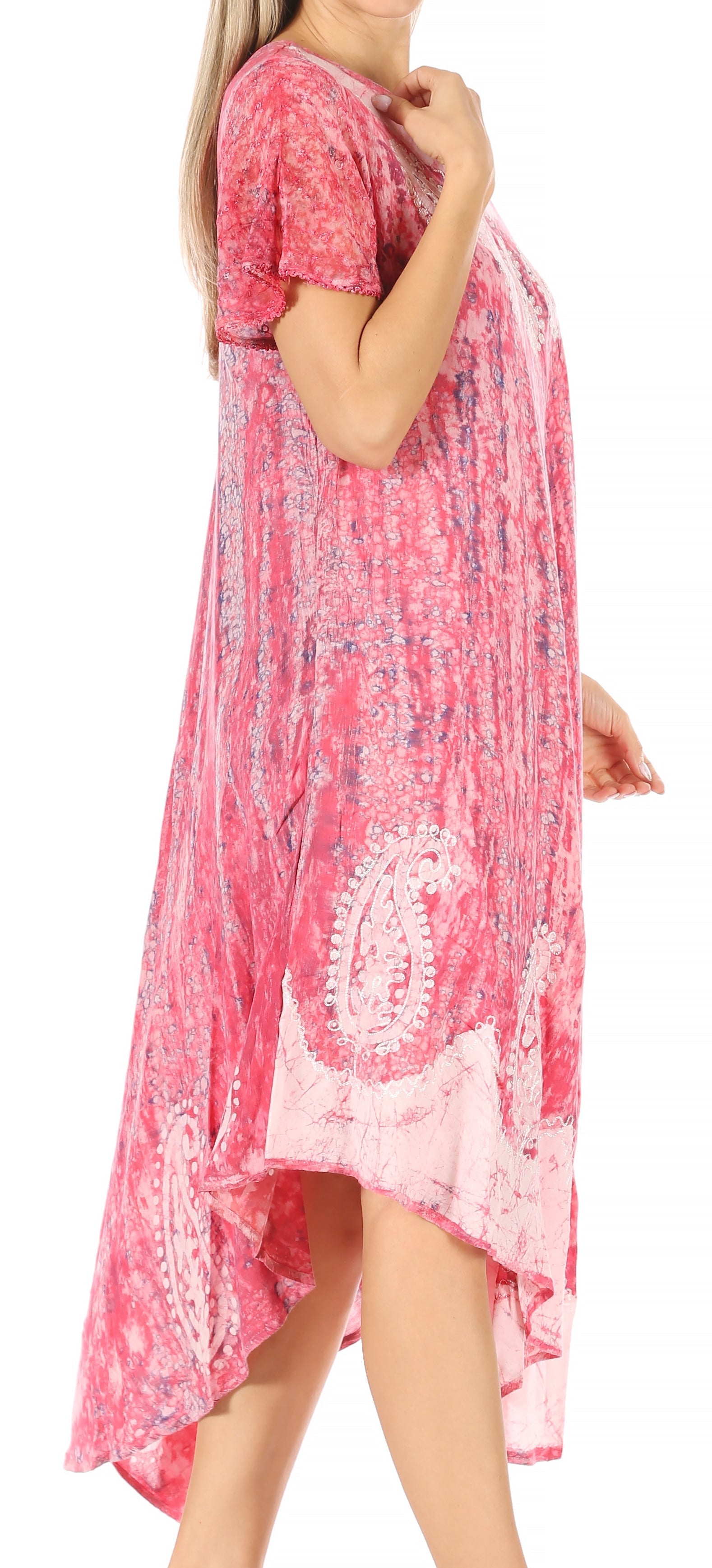 Woman wearing a pink floral dress with a white lace hem on a white background