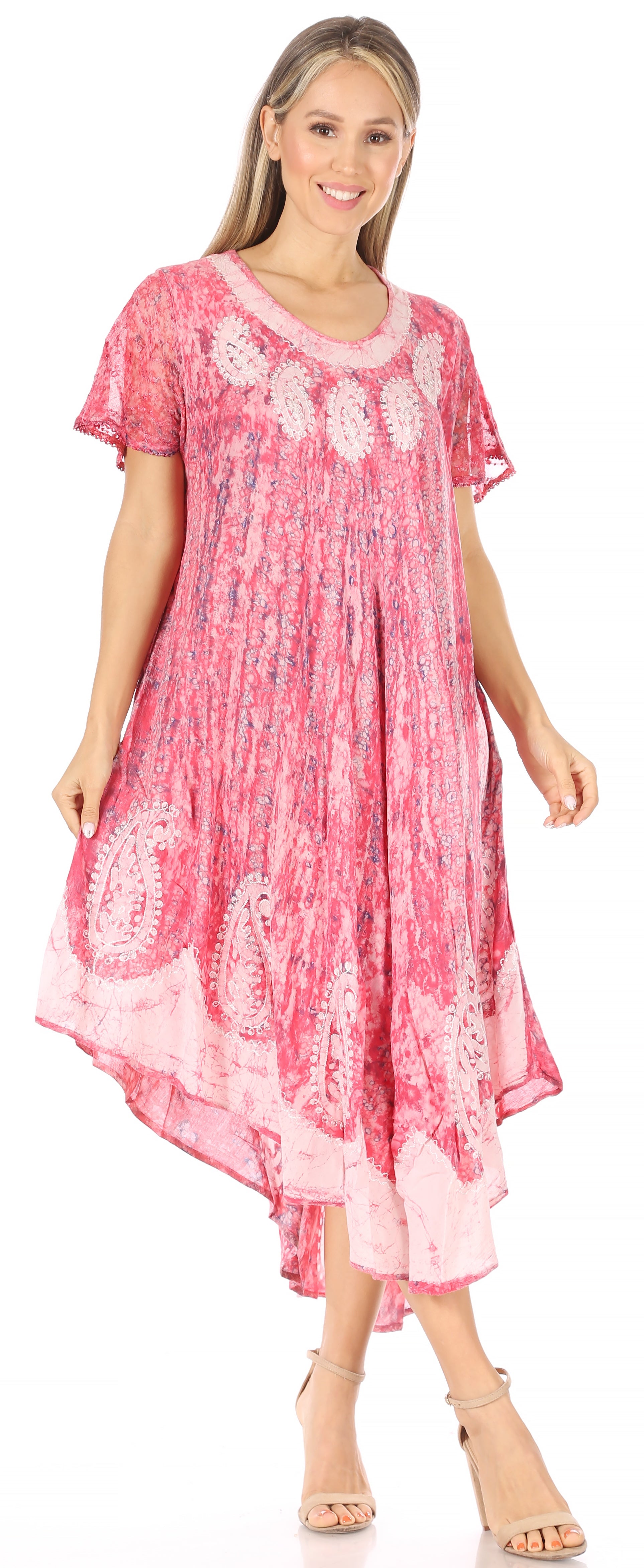 Woman wearing a pink dress with floral patterns on a white background