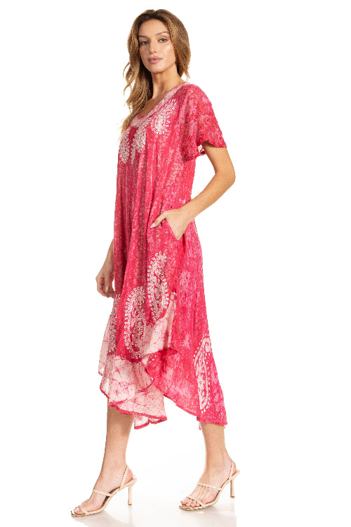 Woman wearing a pink dress with white patterns on a white background
