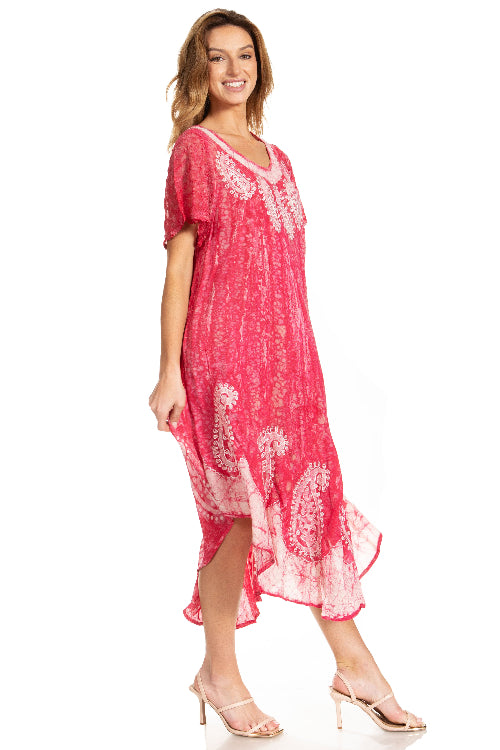 Woman wearing a pink dress with white floral patterns on a white background