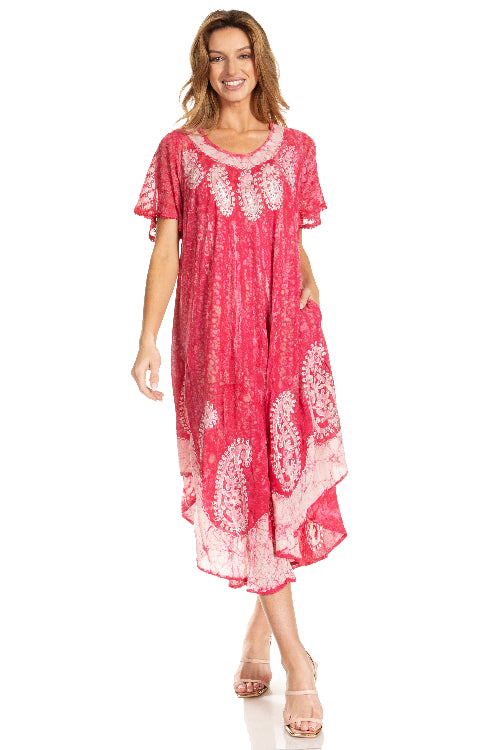 Woman wearing a pink dress with white patterns on a white background