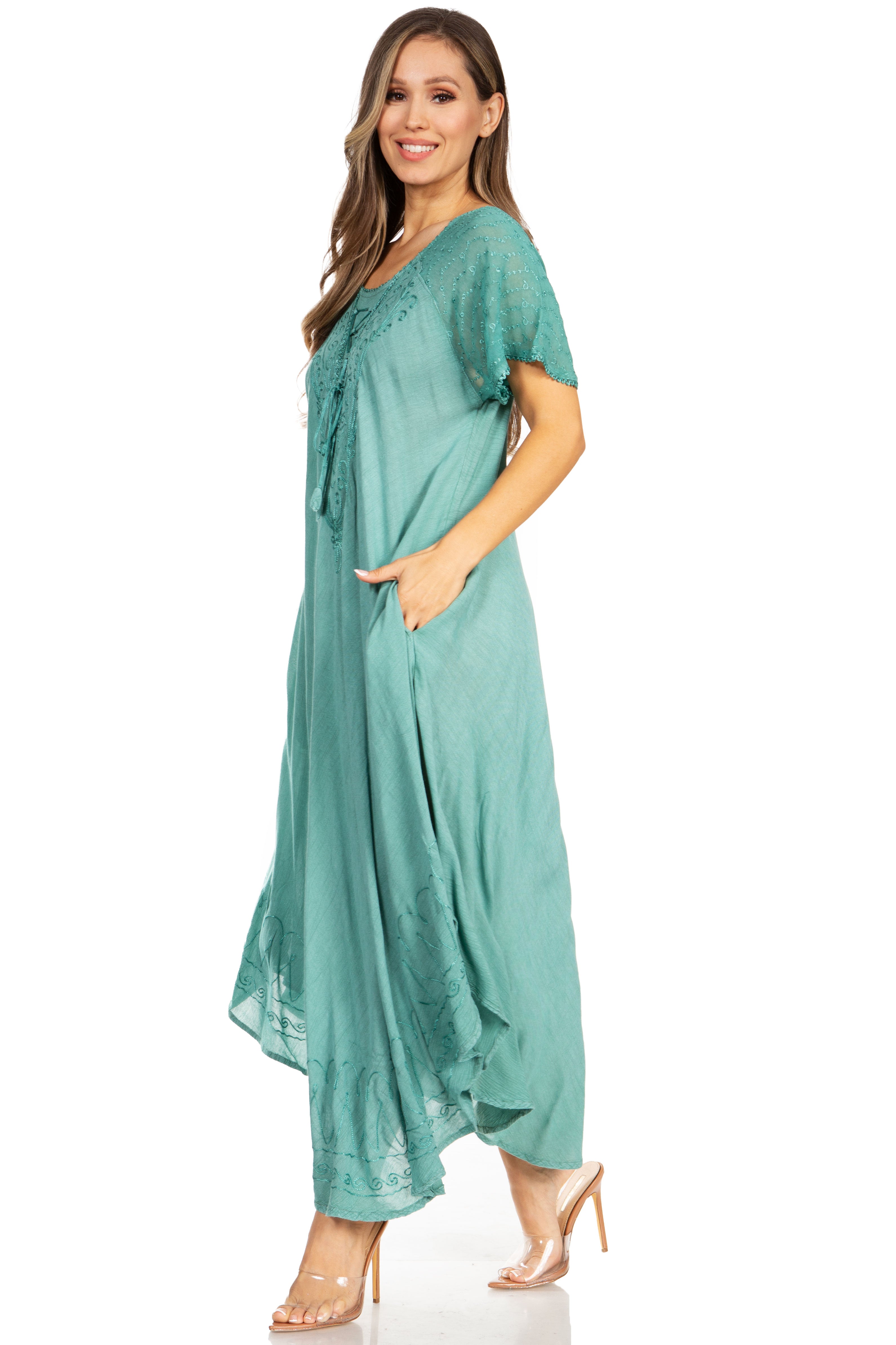 Woman wearing a teal dress on a white background