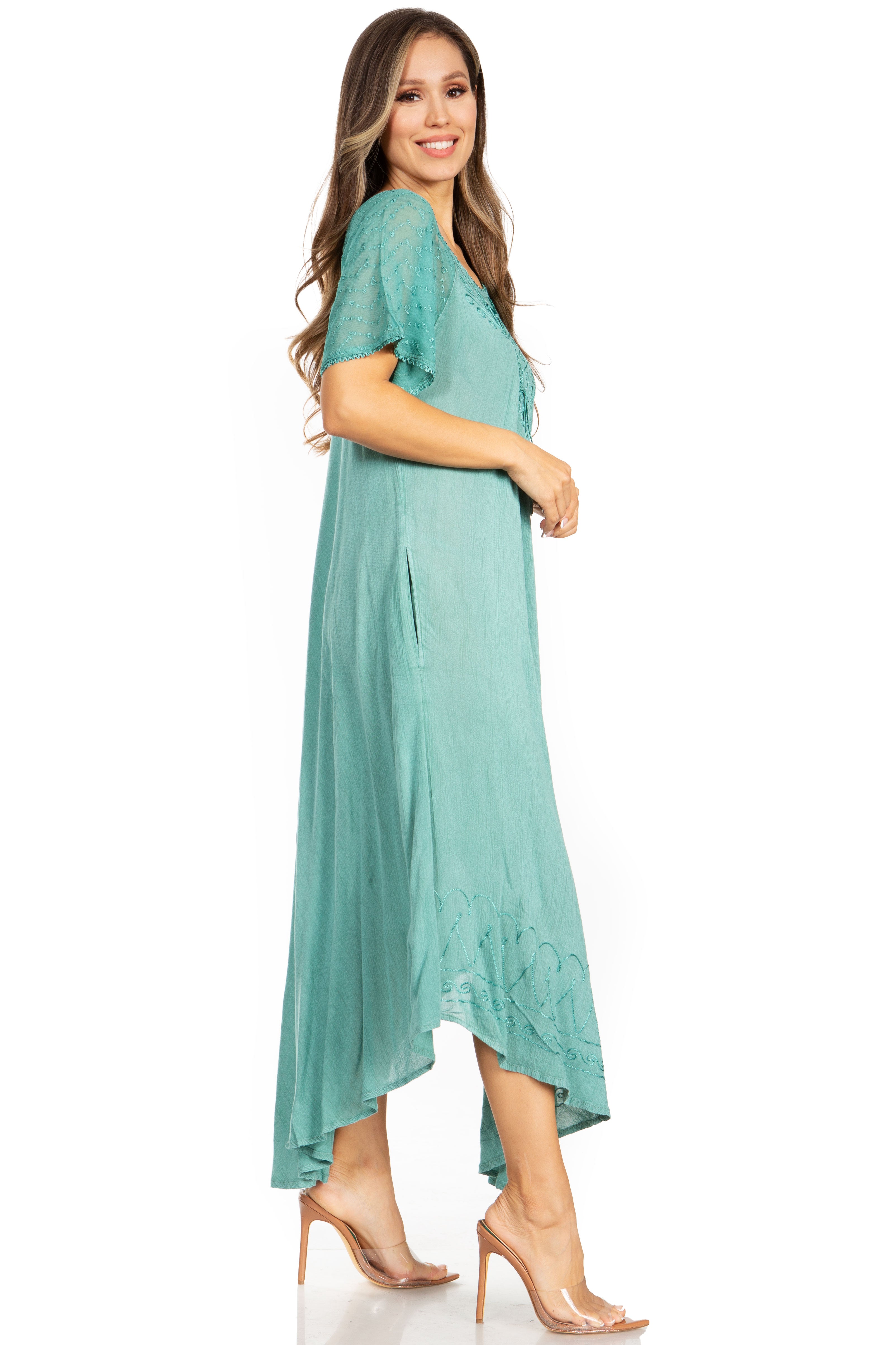 Woman wearing a teal dress on a white background