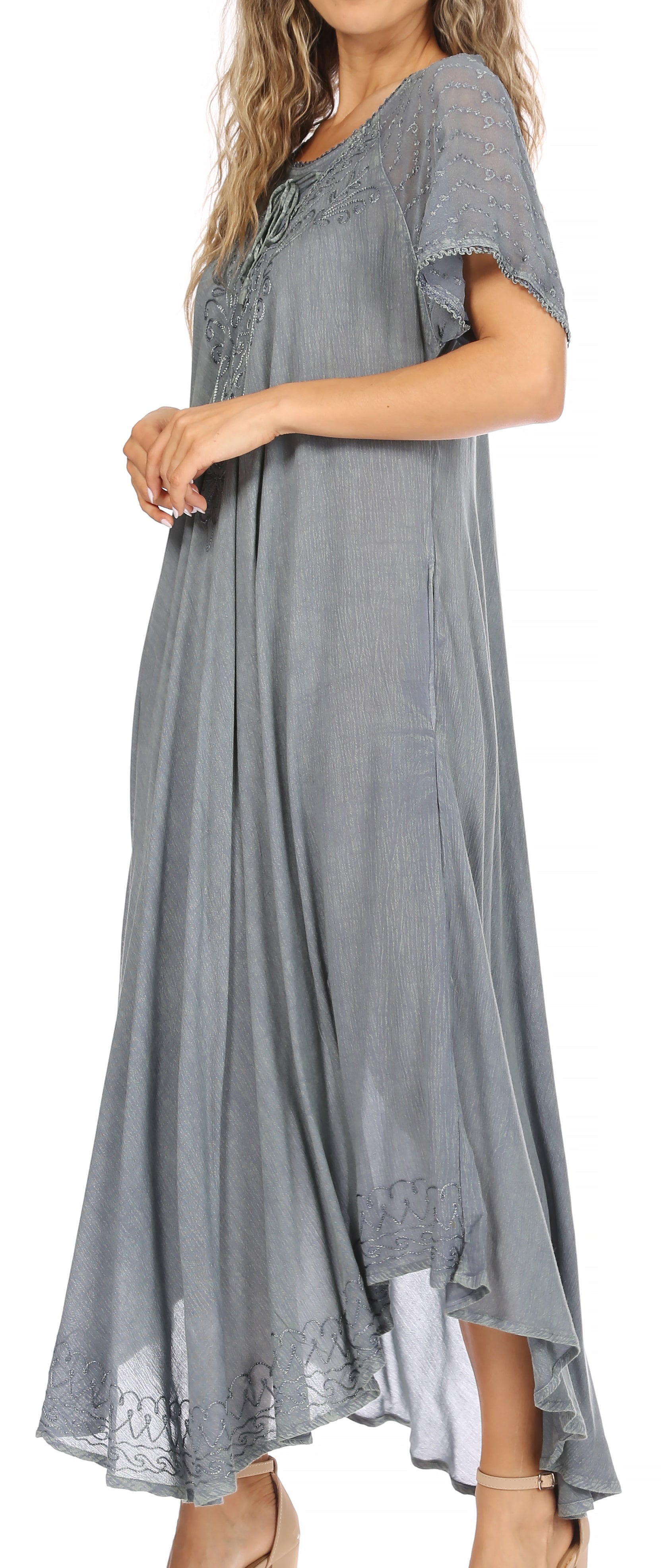 Woman wearing a gray dress with lace details on a white background