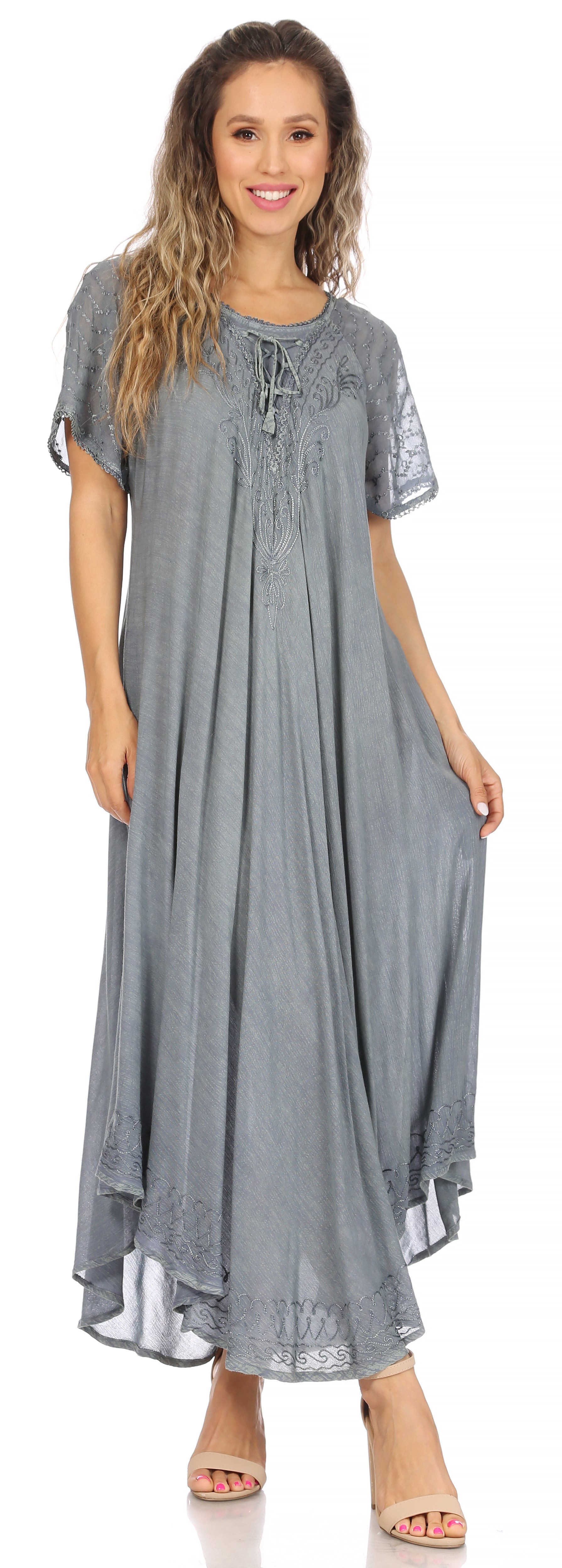 Woman wearing a gray dress with lace details on a white background
