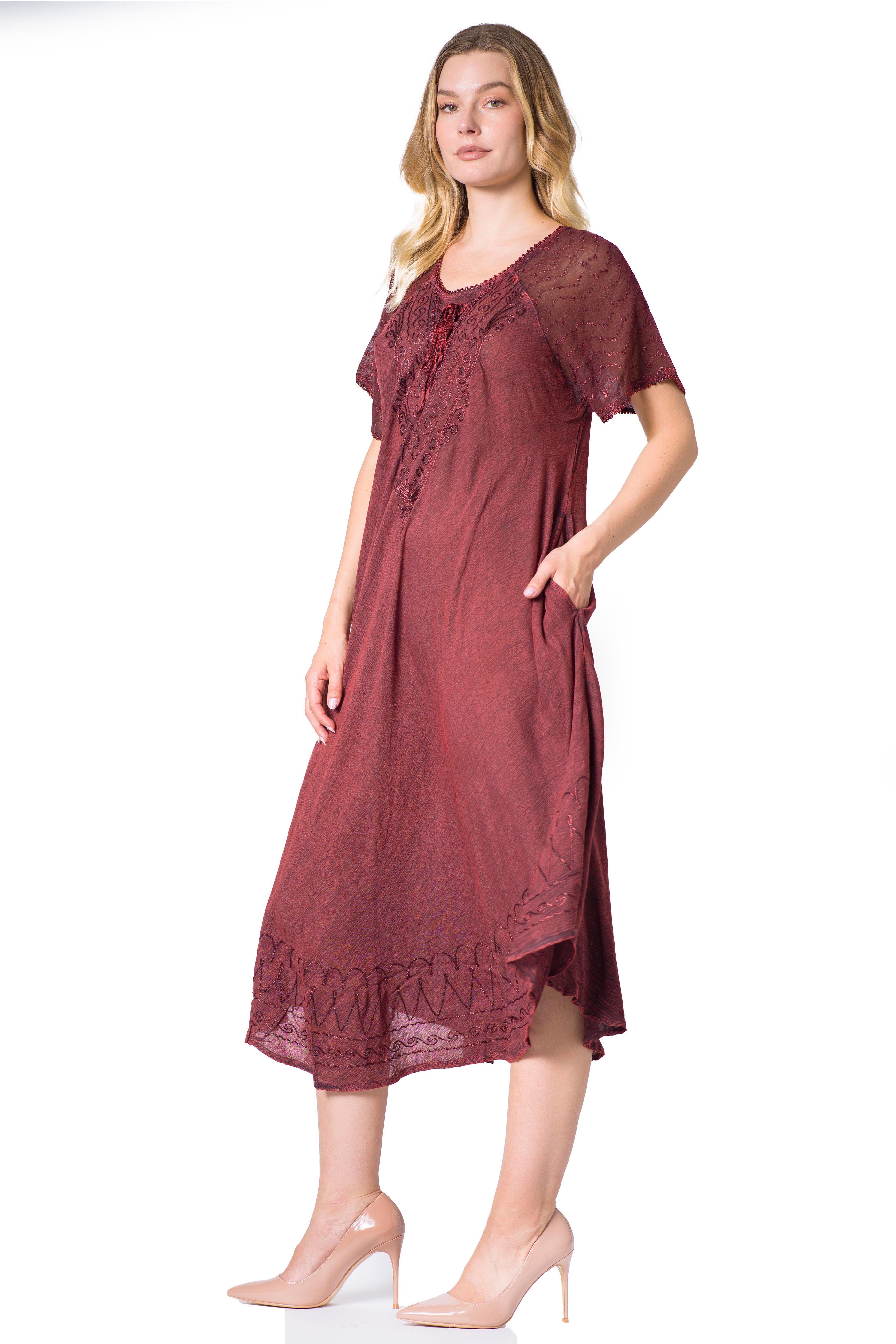 Woman wearing a burgundy dress with lace details on a white background