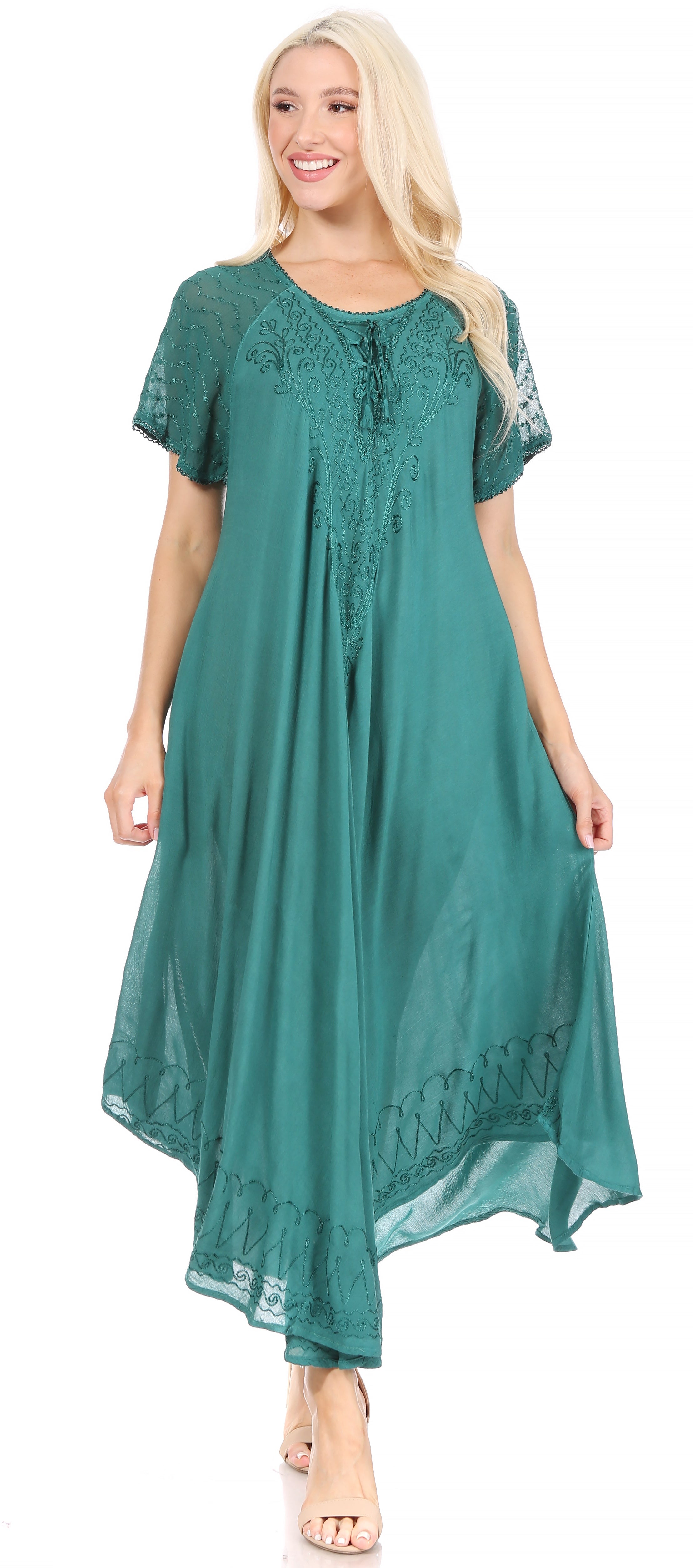 Woman wearing a teal dress with lace details on a white background