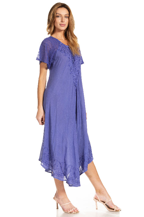 Woman wearing a purple dress with lace details on a white background
