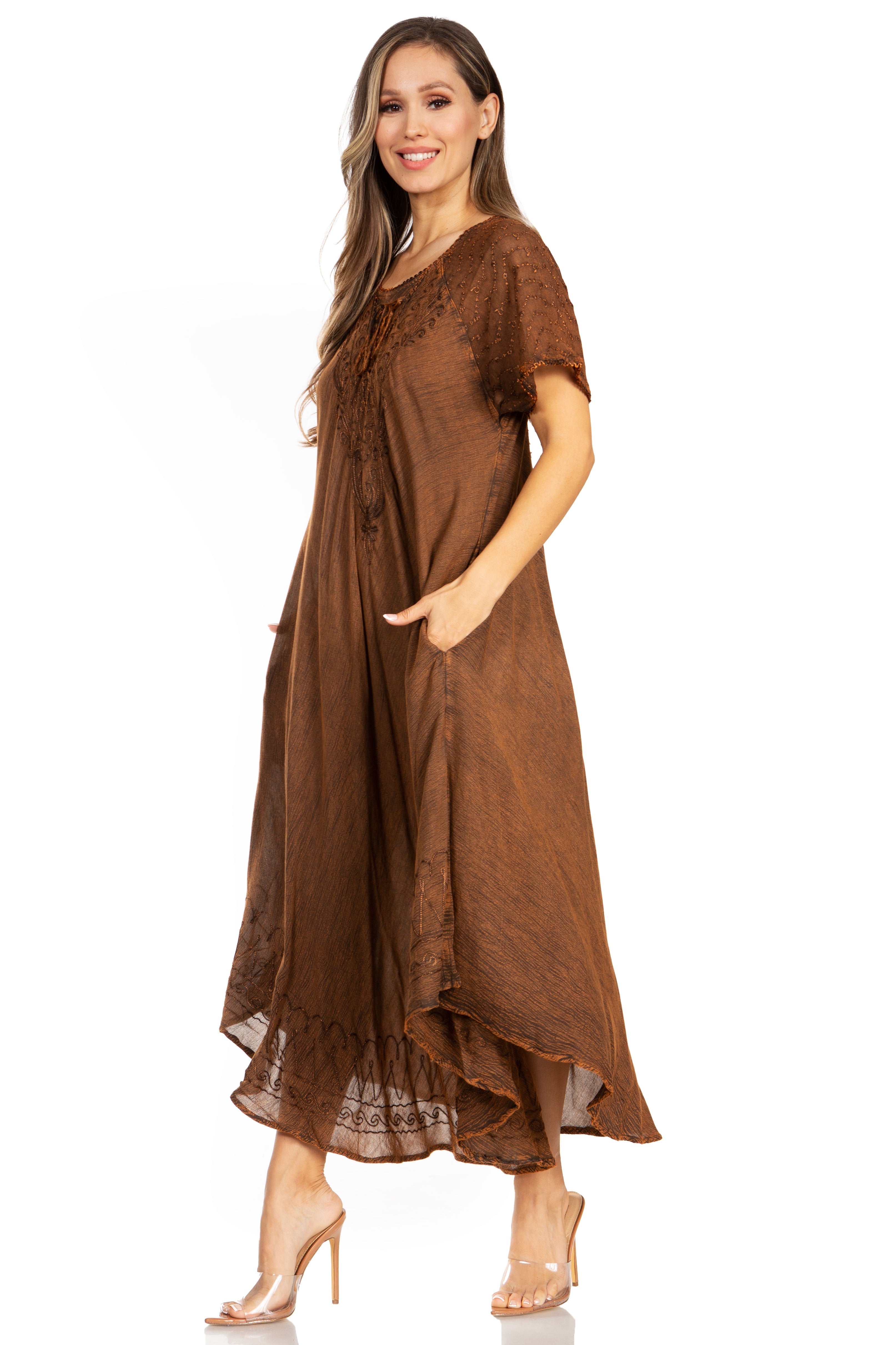 Woman wearing a brown dress with lace details on a white background