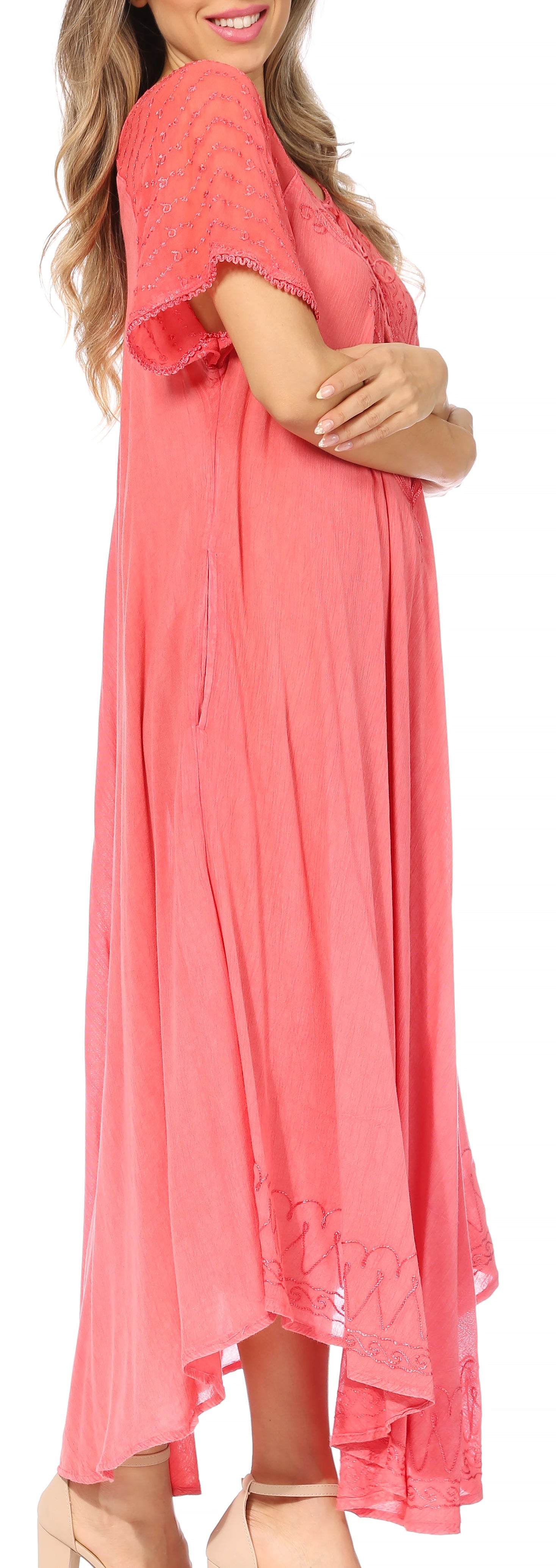Woman wearing a coral dress with a plain background