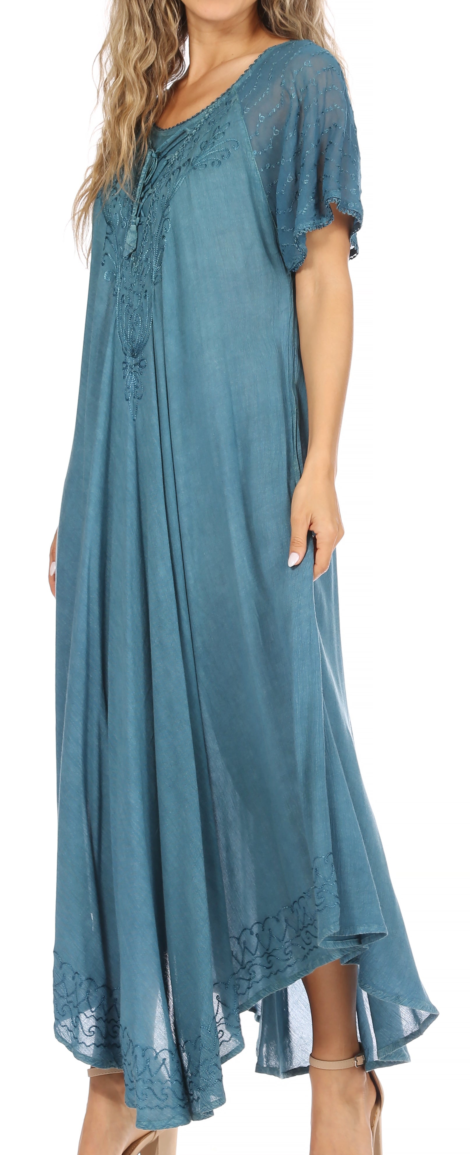 Woman wearing a blue dress with lace details on a white background