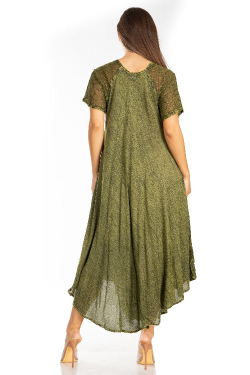 Woman wearing a green dress with sheer sleeves on a white background