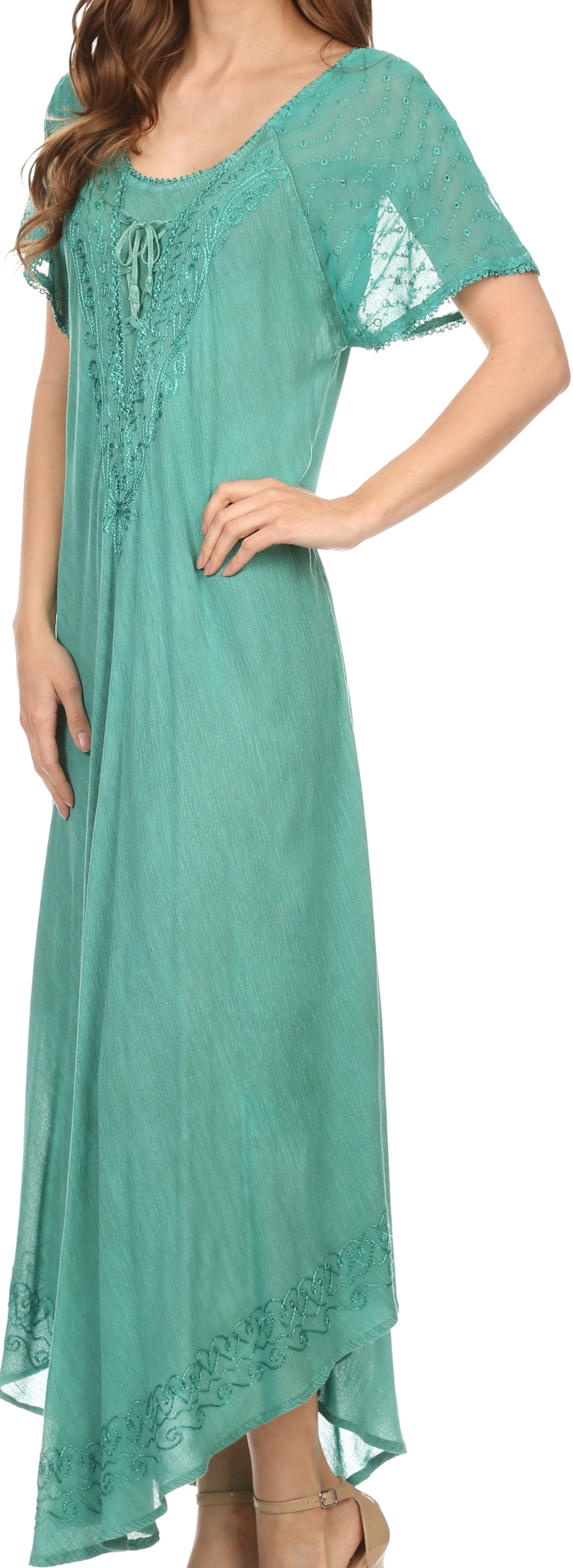 Woman wearing a teal dress with lace details on a white background