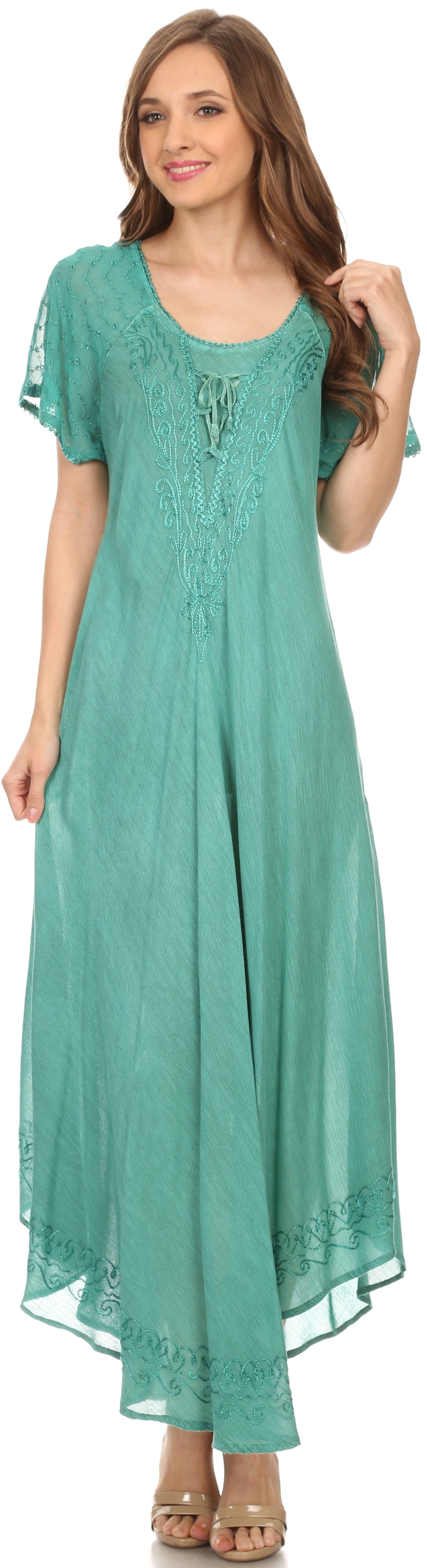 Woman wearing a teal dress with short sleeves and lace details on a white background