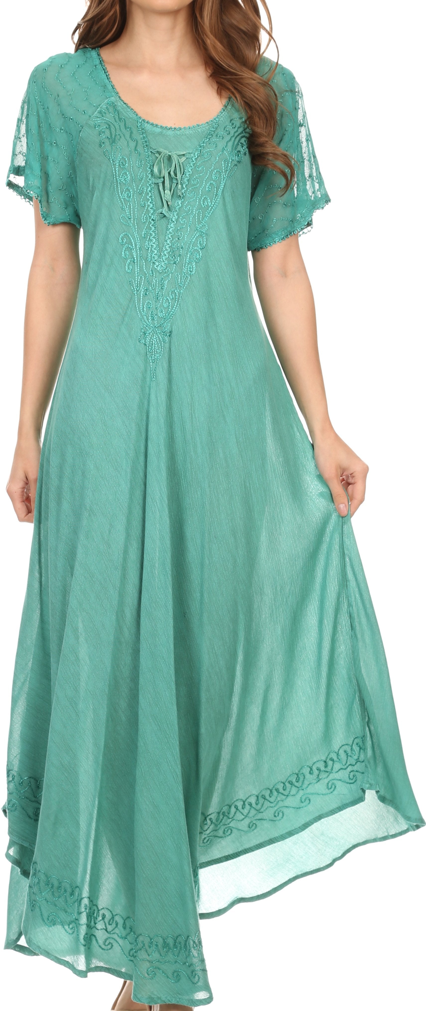 Woman wearing a teal dress with lace details on a white background