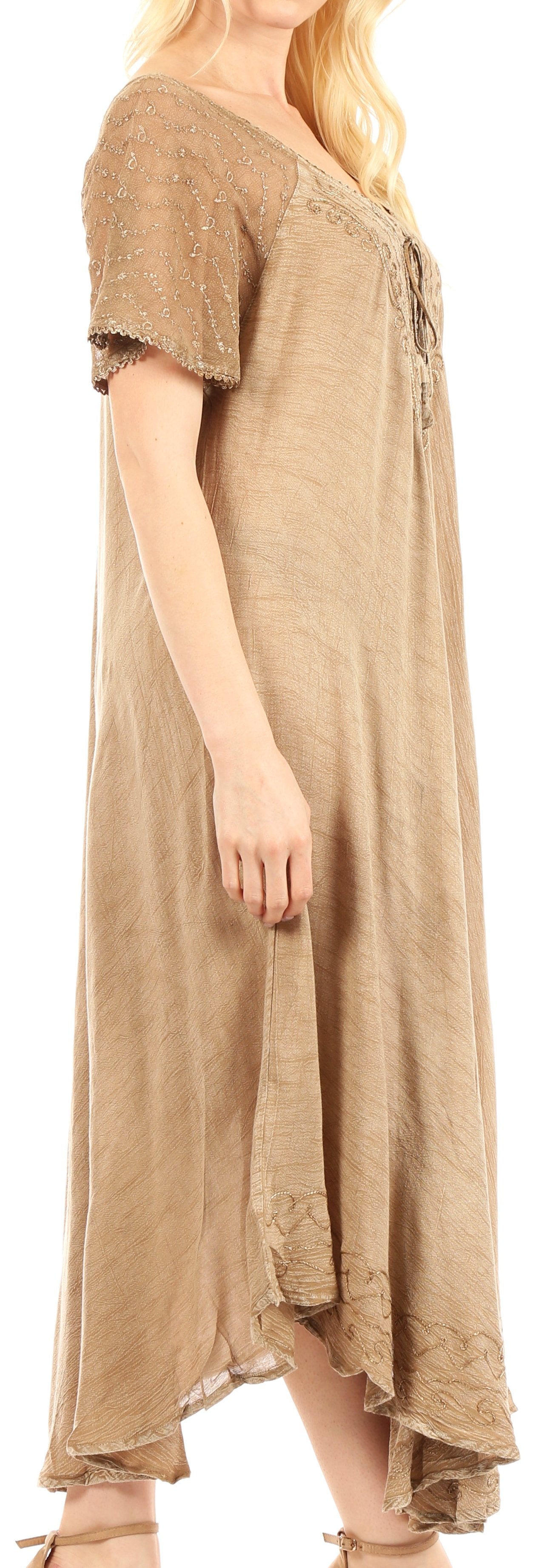 Woman wearing a long beige dress with a plain background