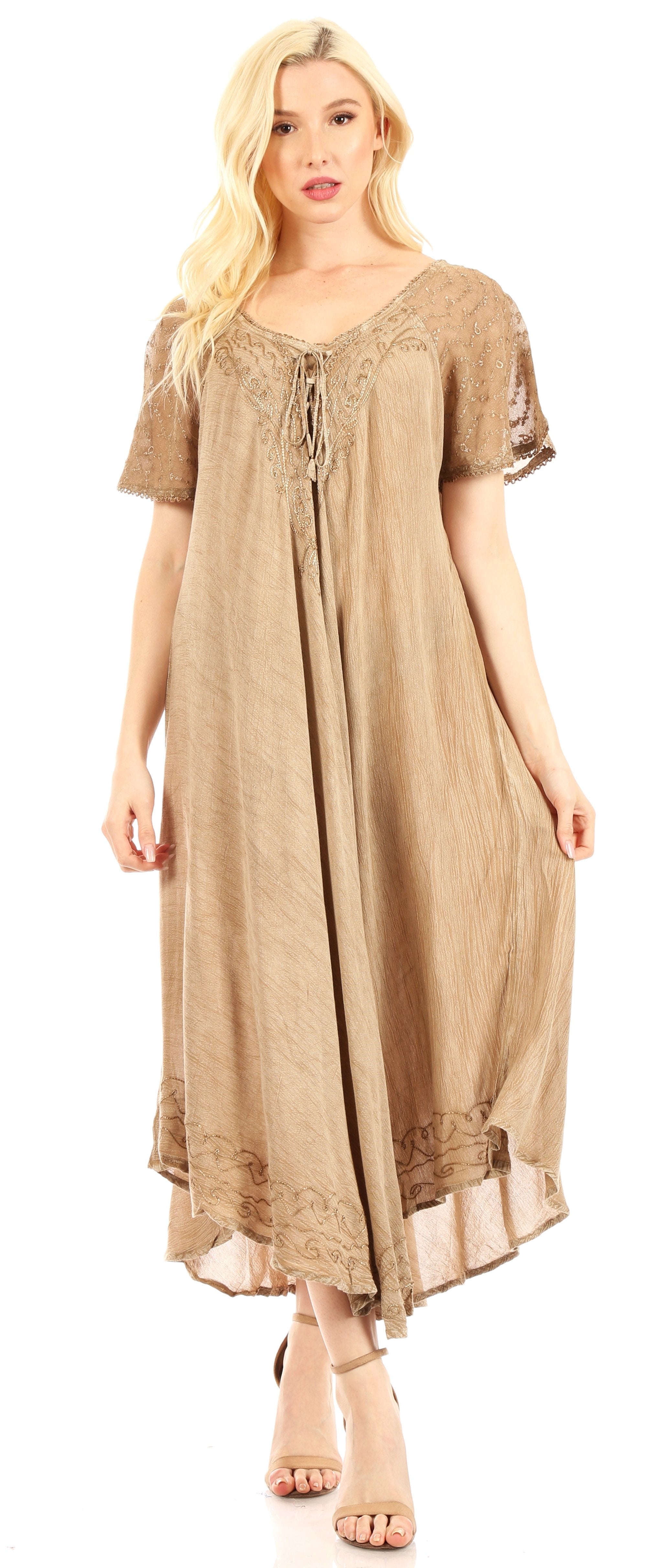 Woman wearing a beige dress with lace details on a white background