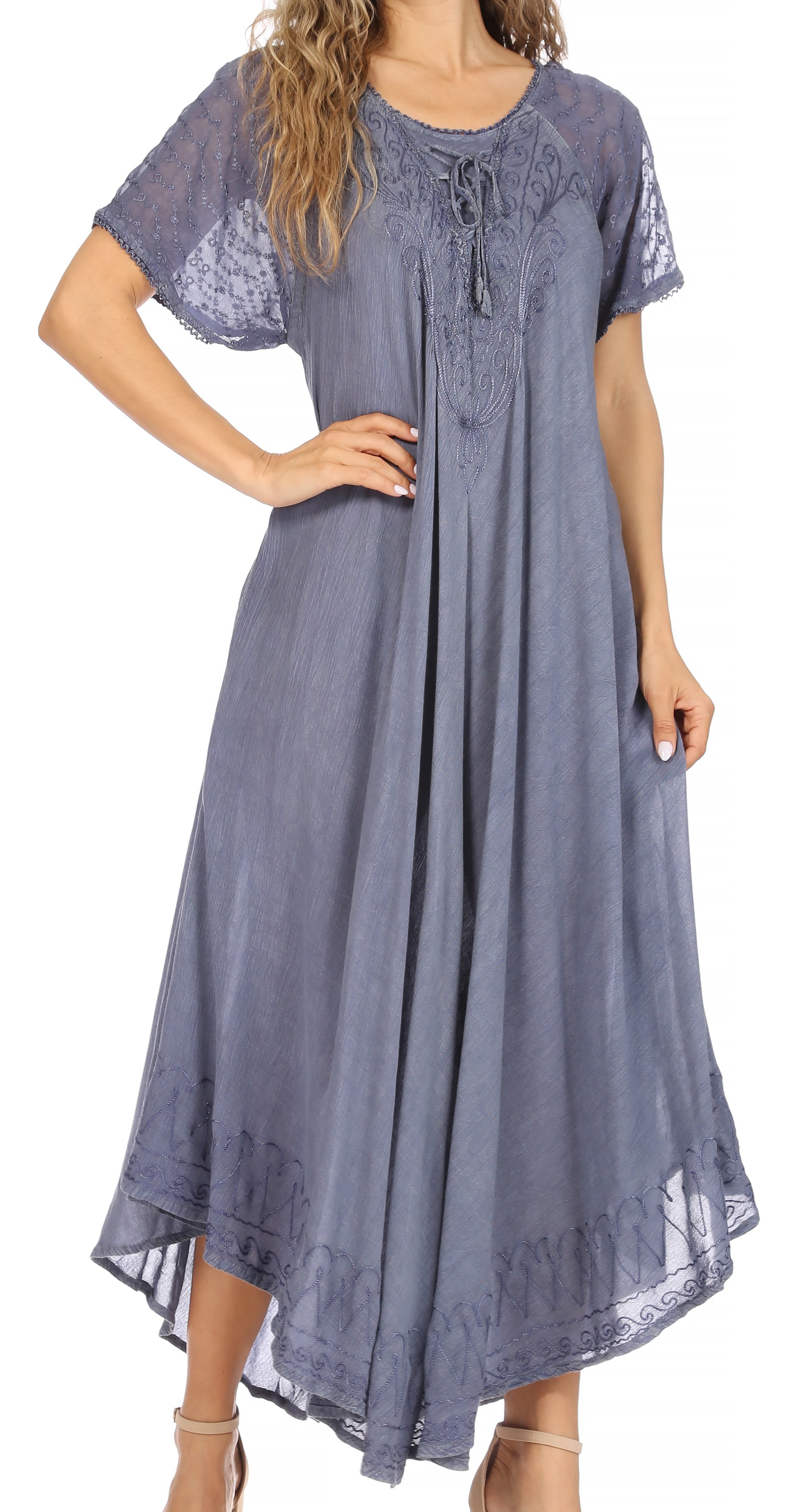 Woman wearing a long blue dress with lace details on a white background