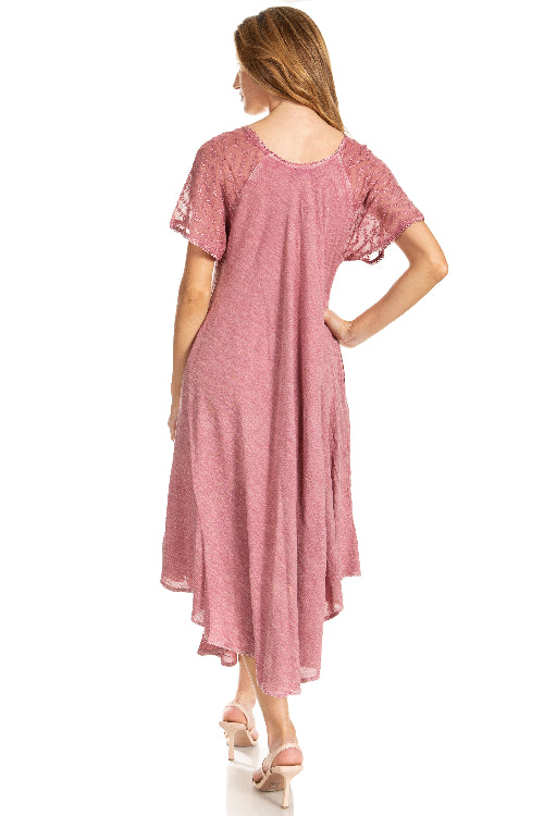 Woman wearing a pink dress with lace sleeves on a white background
