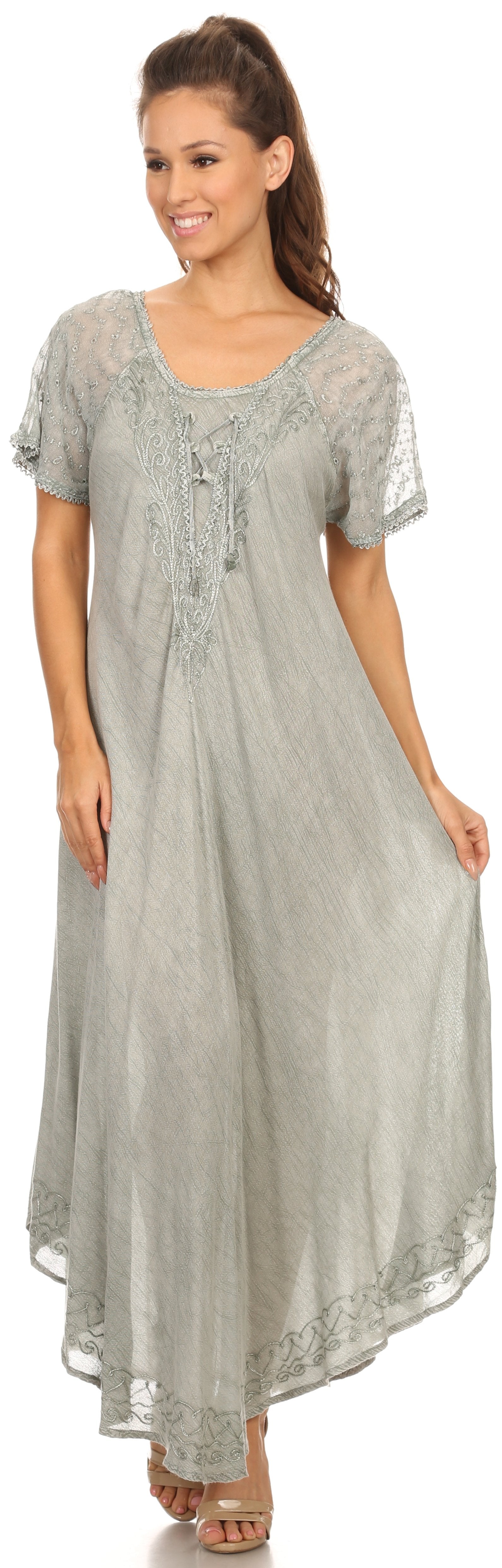 Woman wearing a long gray dress with lace details on a white background