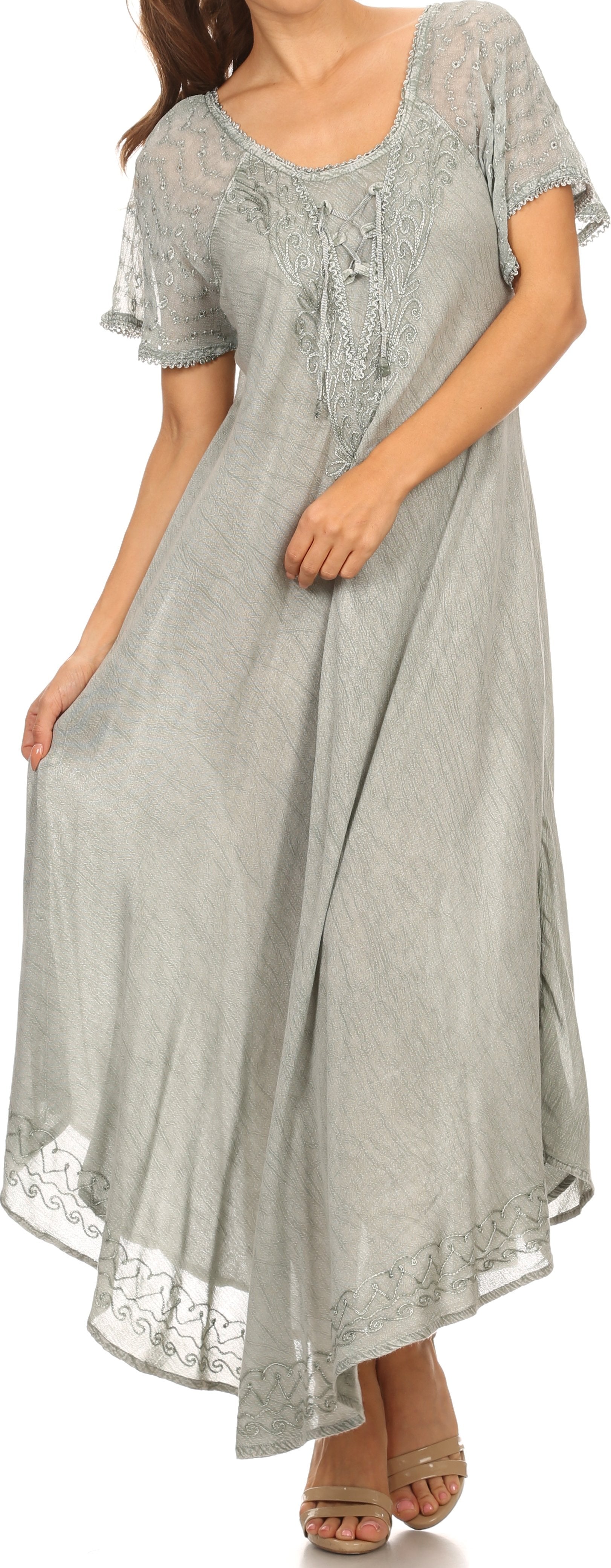 Woman wearing a long gray dress with lace details on a white background