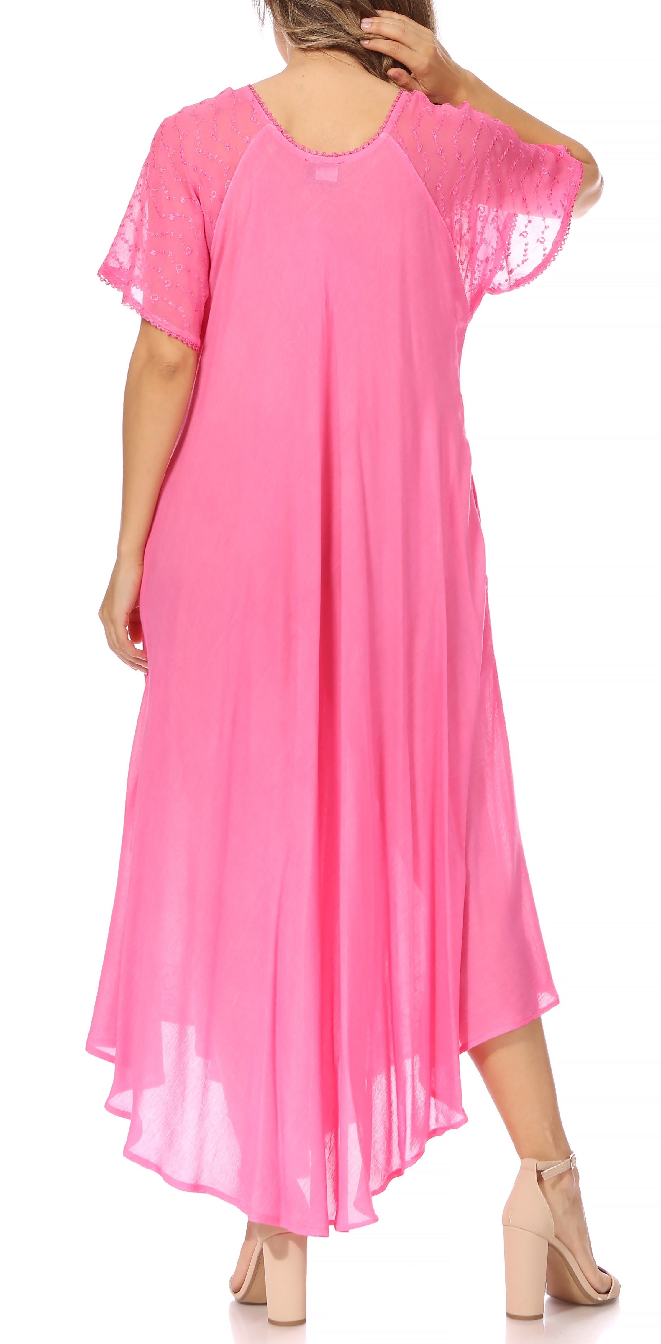 Pink dress with sheer sleeves worn by a model on a white background