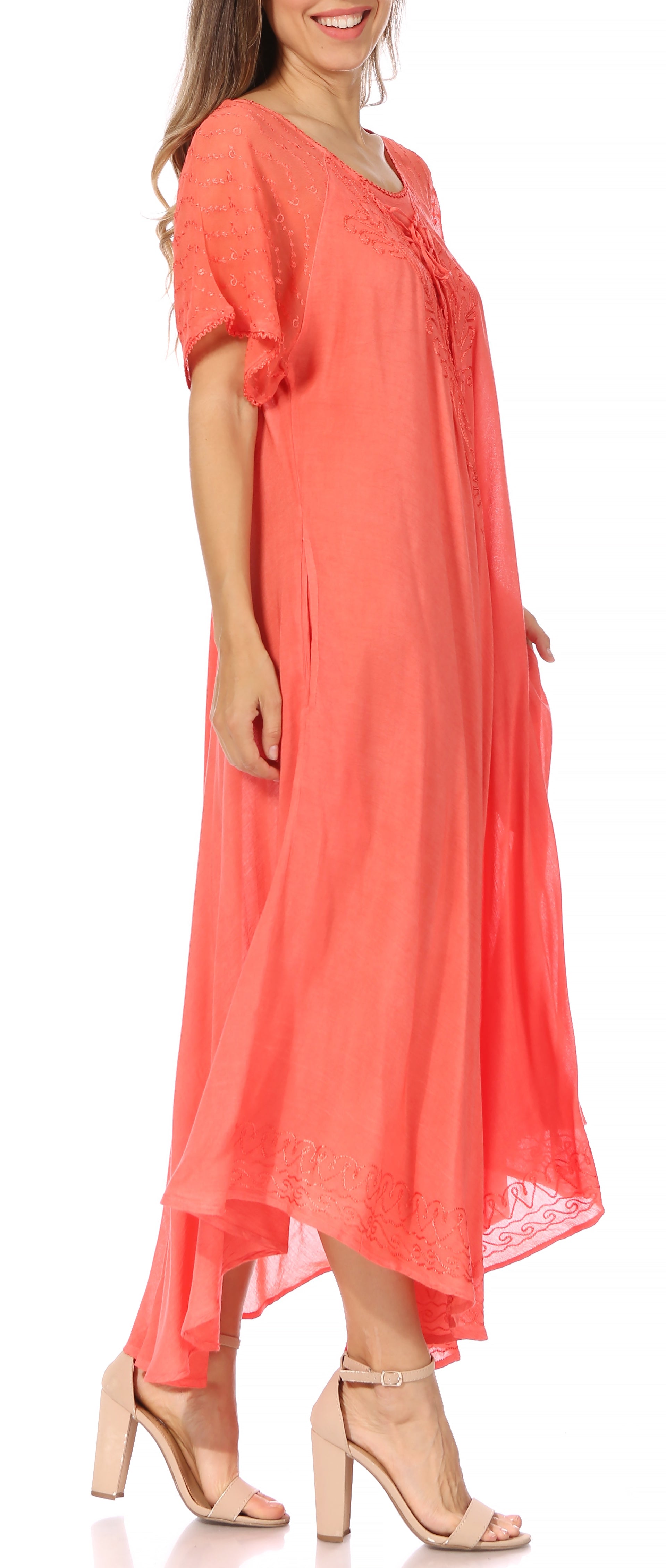 Woman wearing a coral dress on a white background