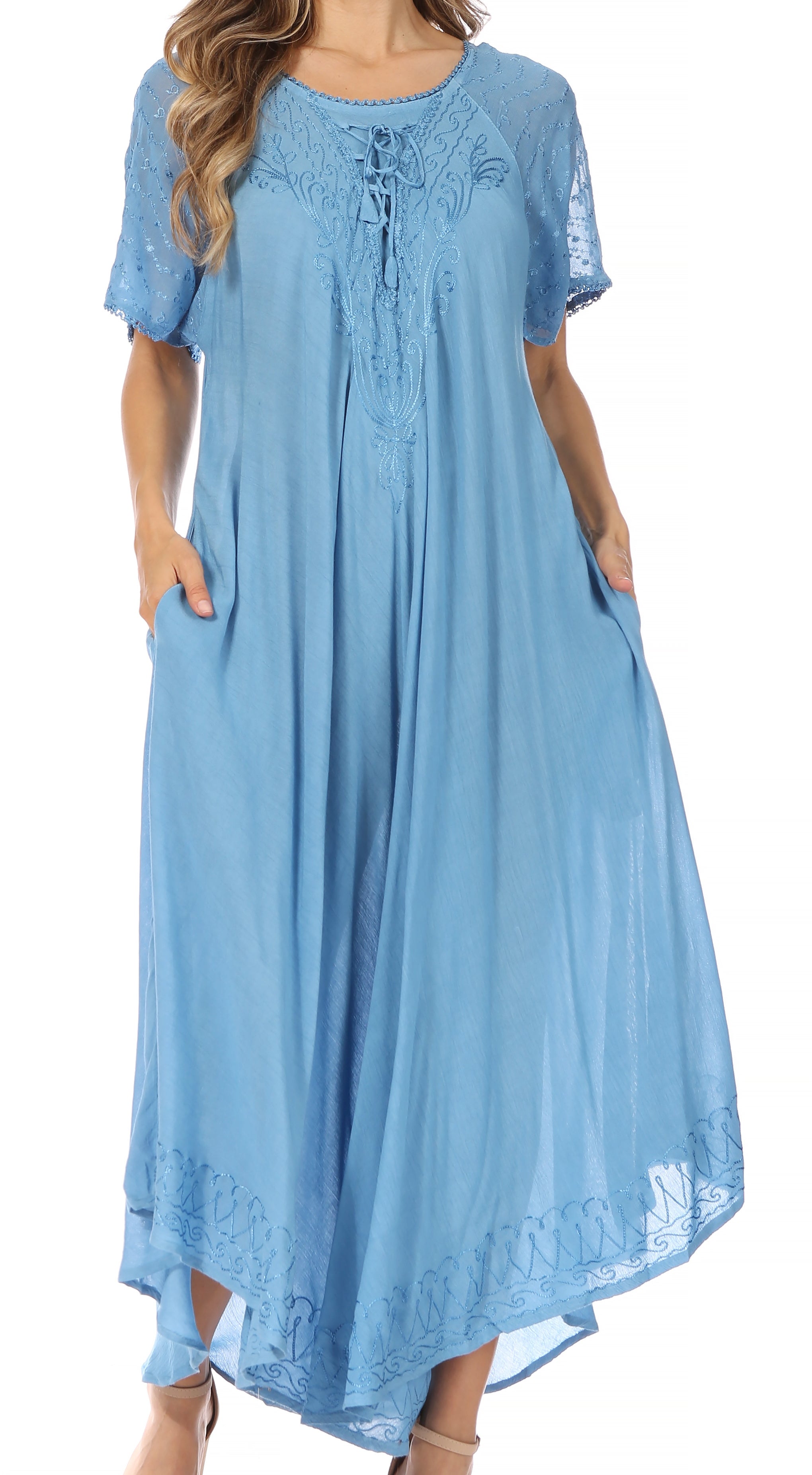 Woman wearing a blue dress with lace details on a white background