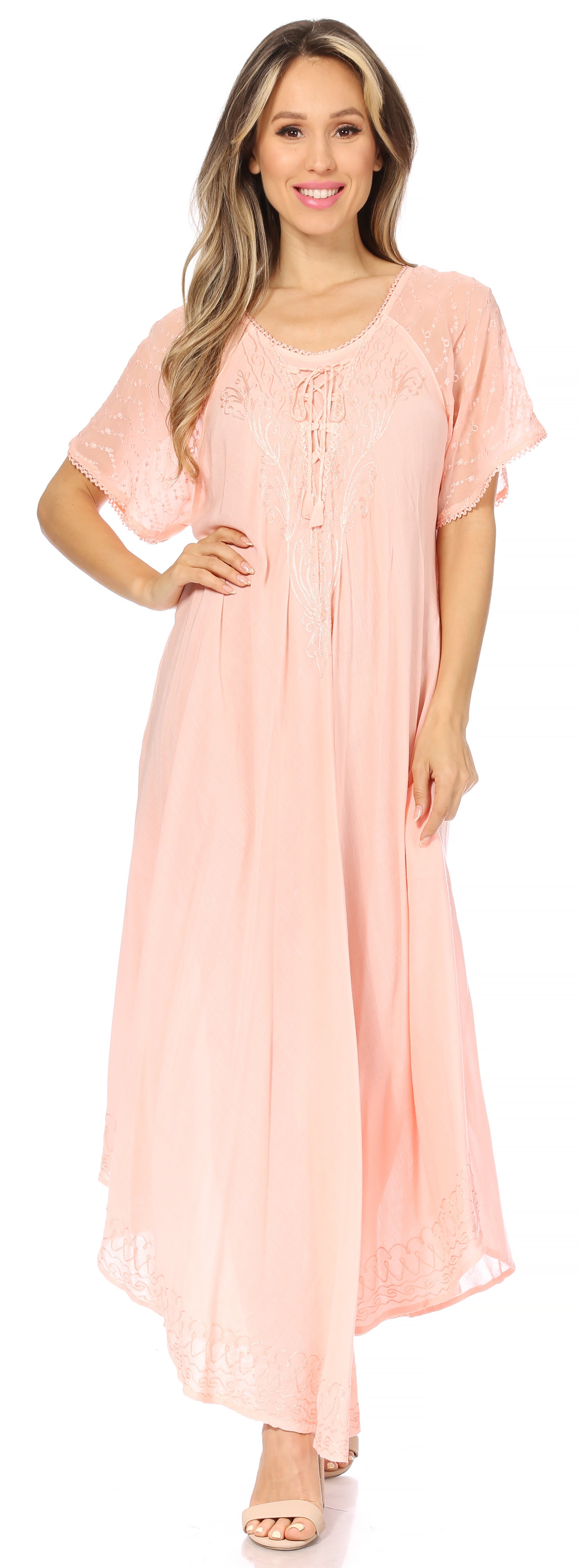 Woman wearing a long, flowing rust-colored dress with lace sleeves on a white background