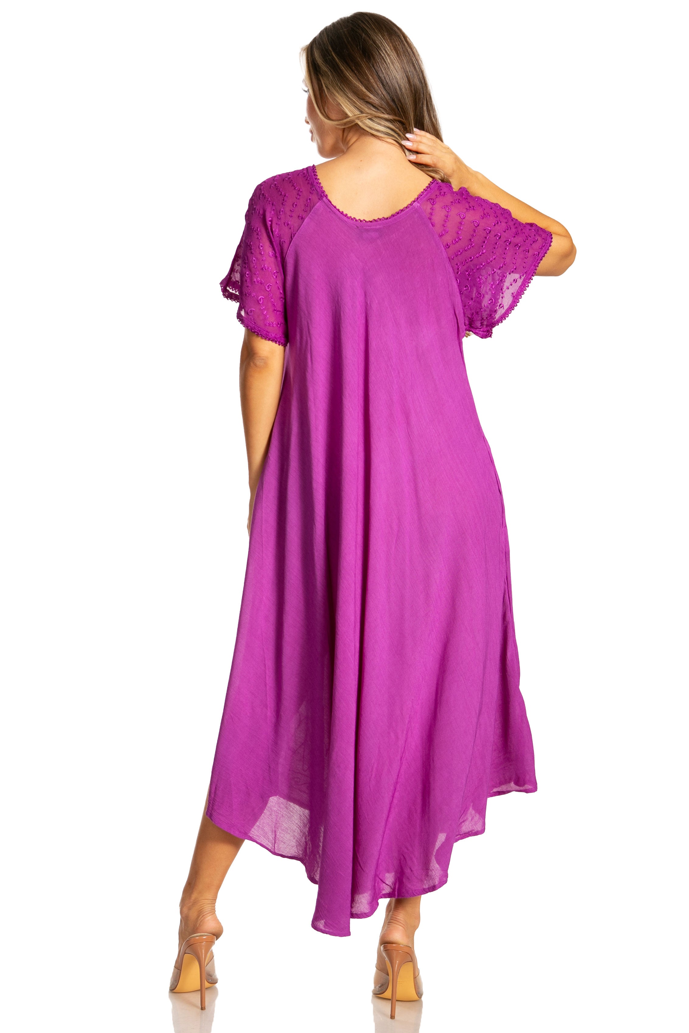 Woman wearing a long, flowing Purple-colored dress with lace sleeves on a white background