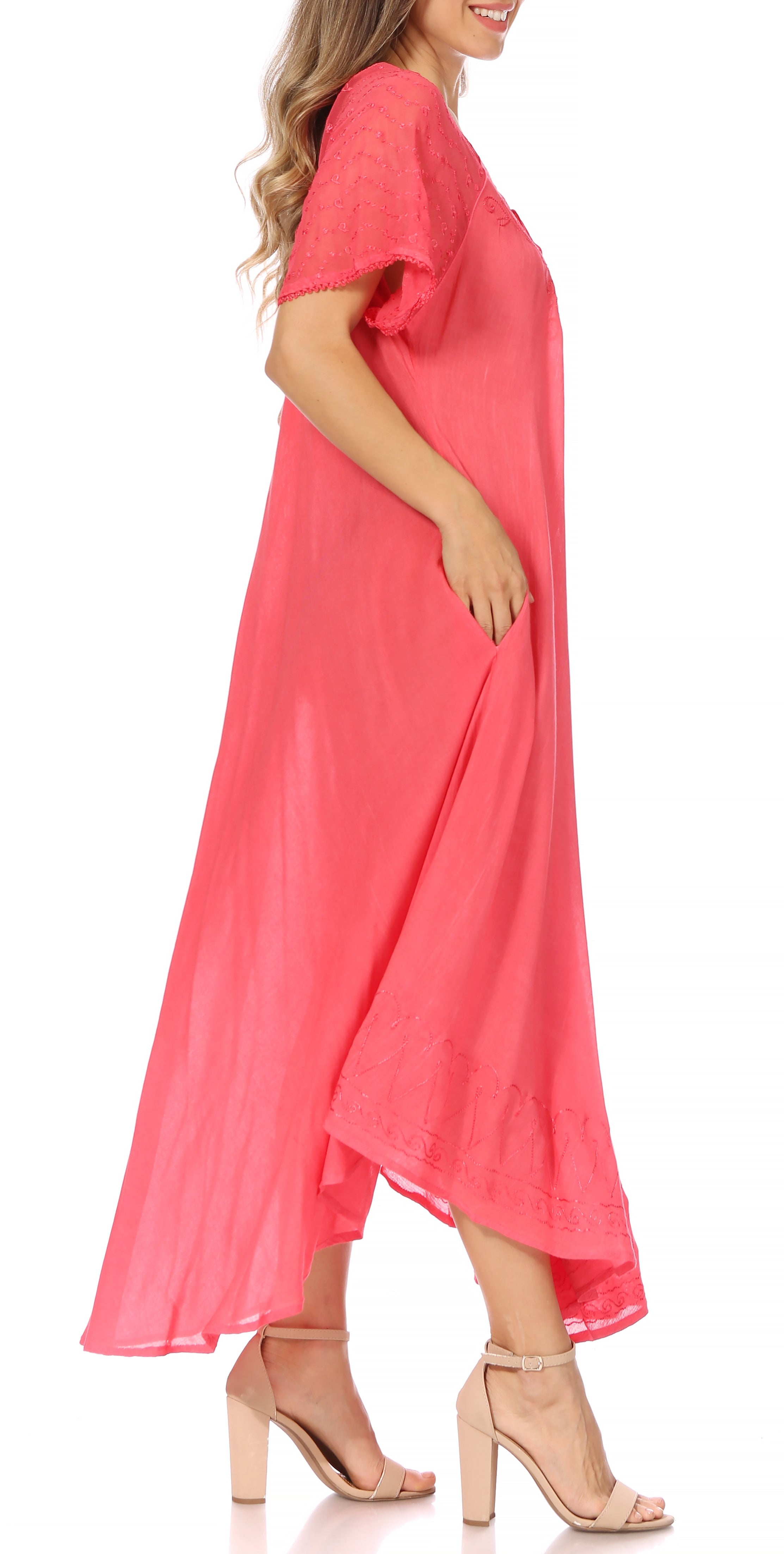 Woman wearing a coral pink dress on a white background