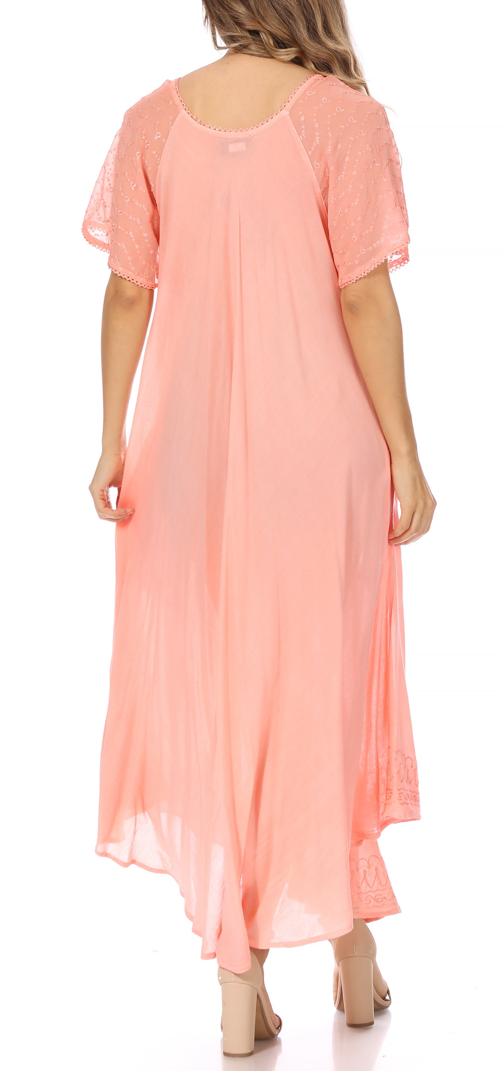 Woman wearing a peach-colored dress on a white background