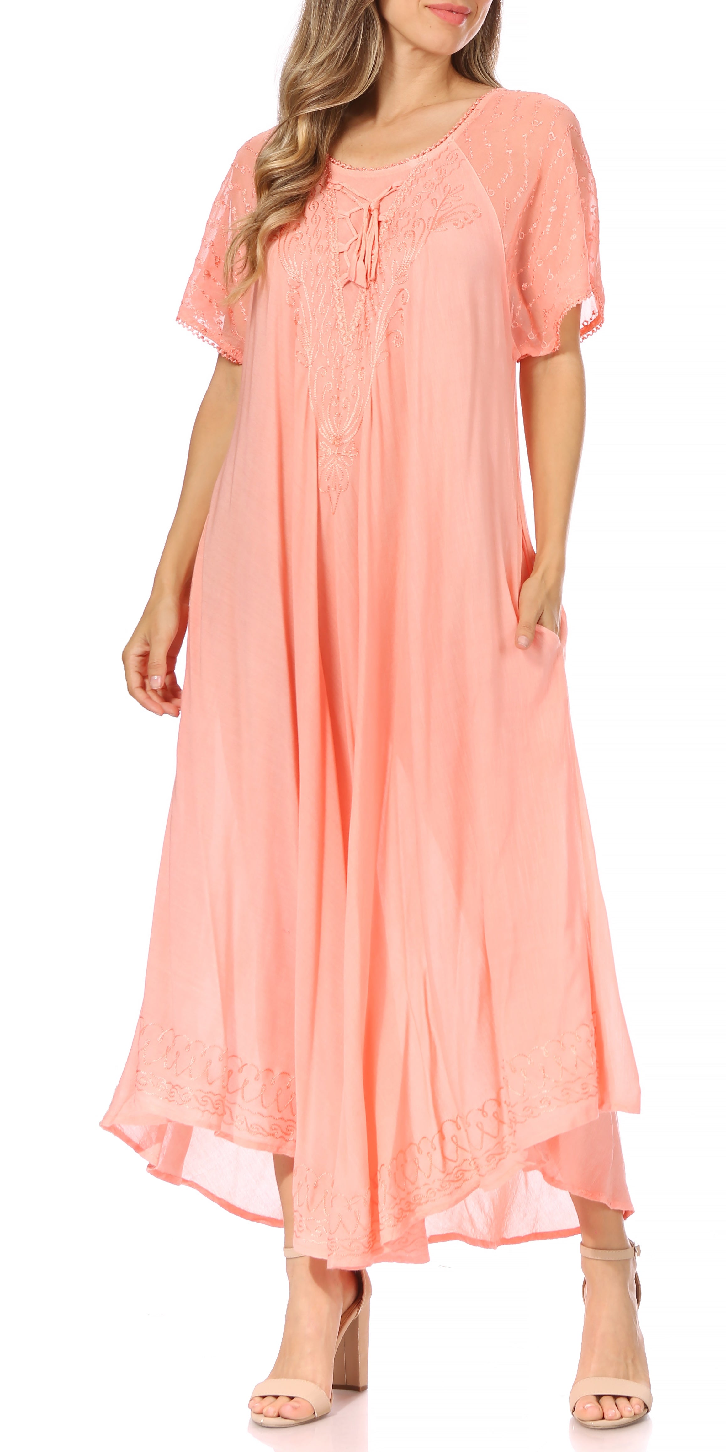 Woman wearing a peach-colored dress with a white background