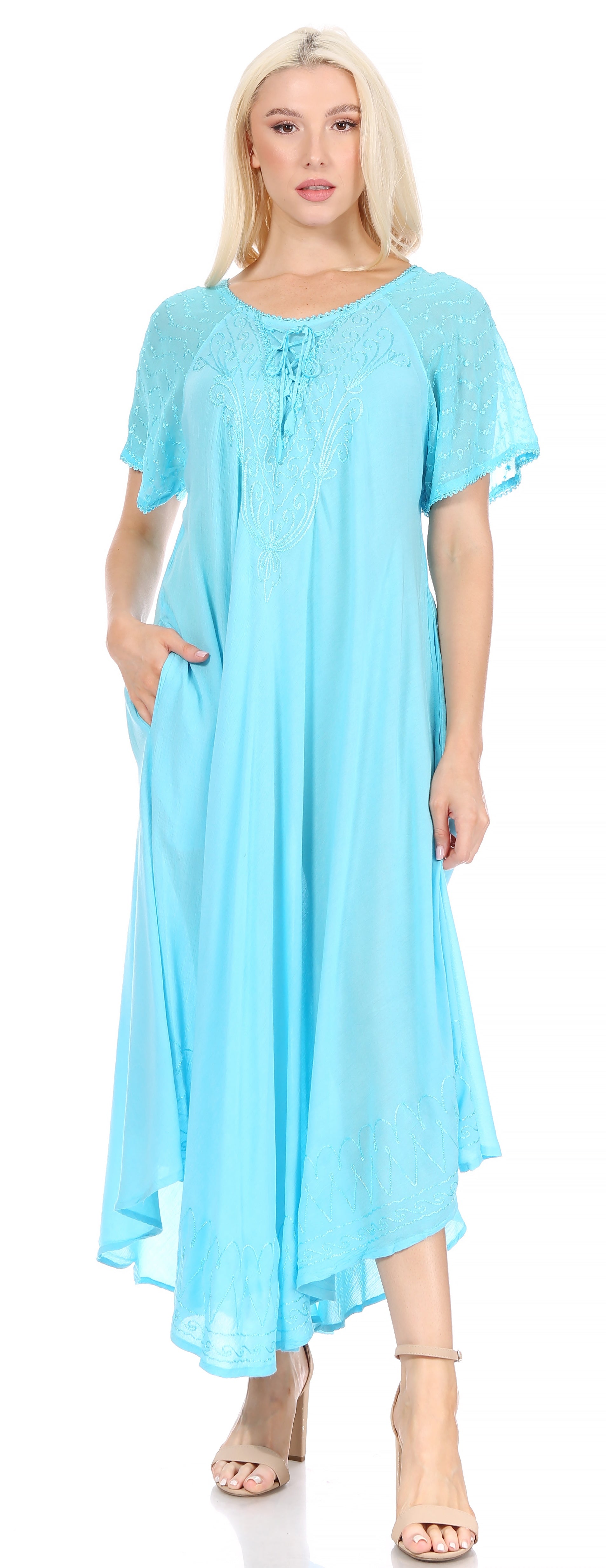 Woman wearing a light blue dress with a plain background