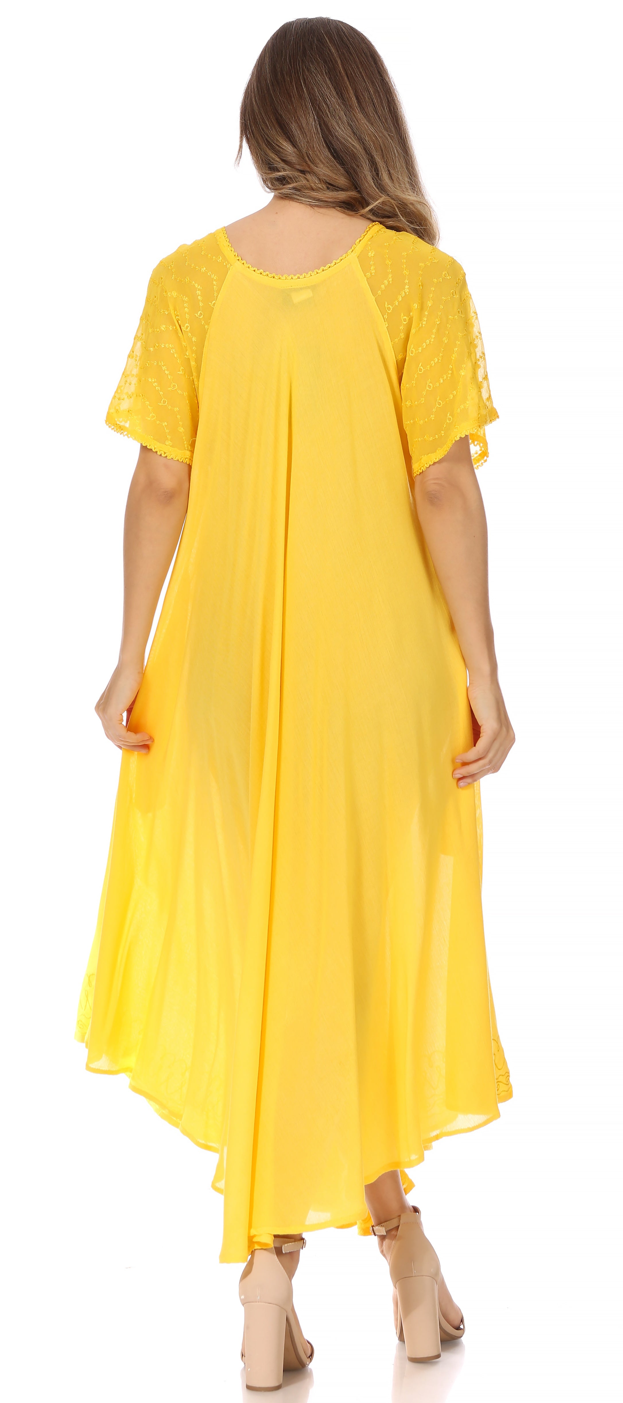 Woman wearing a yellow dress with a plain background