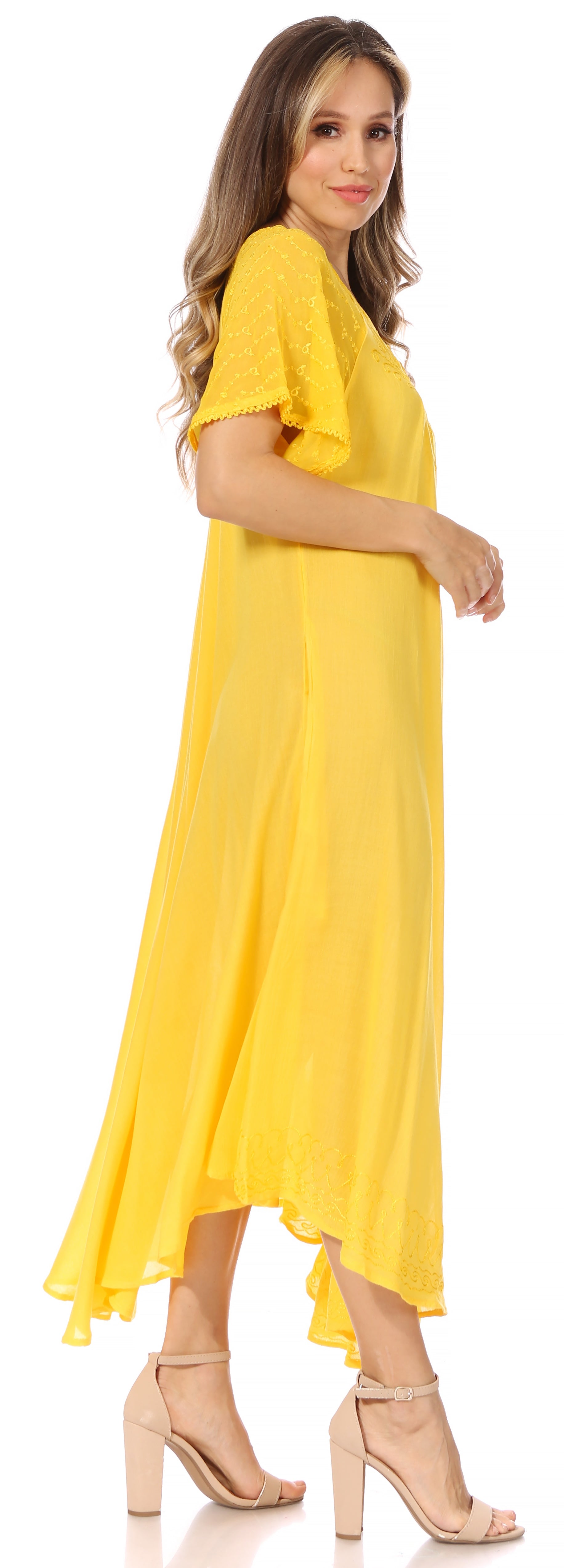 Woman wearing a yellow dress with a plain background