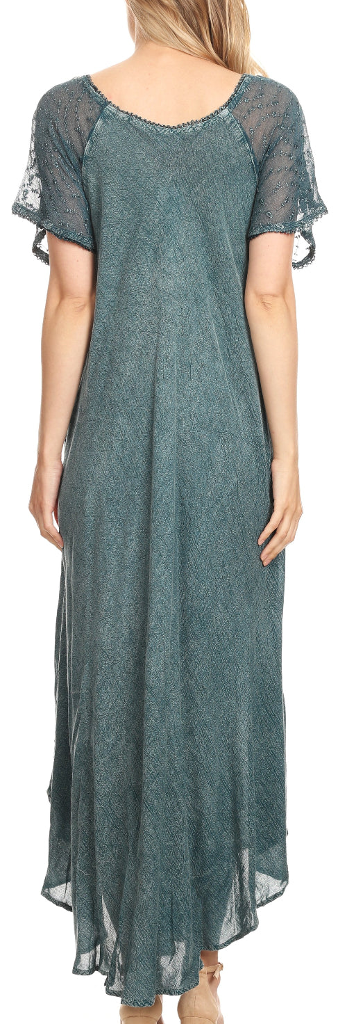 Green dress with sheer sleeves and back, worn by a person.