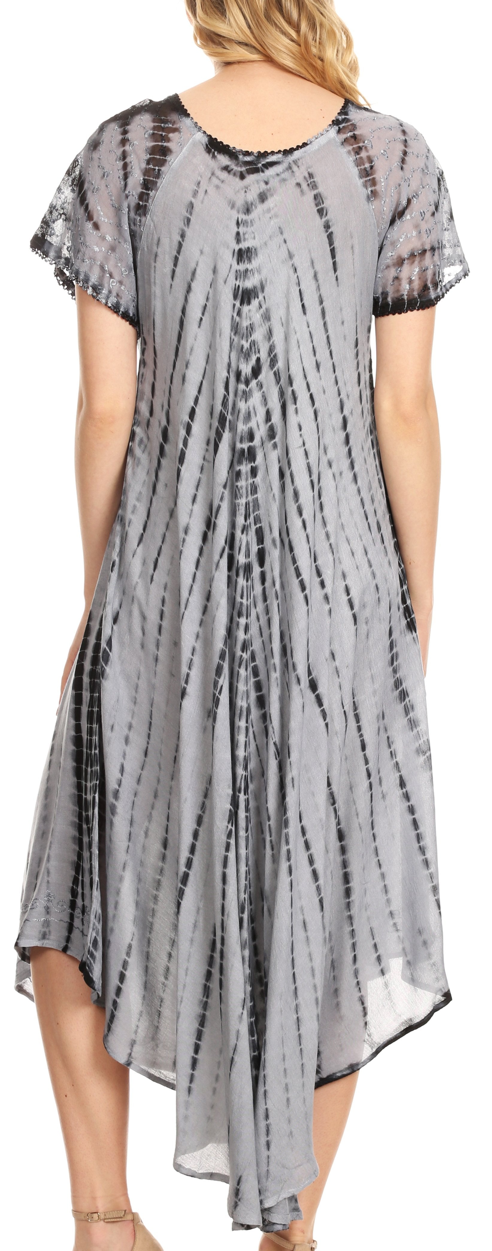 Woman wearing a gray tie-dye dress with a blurred background