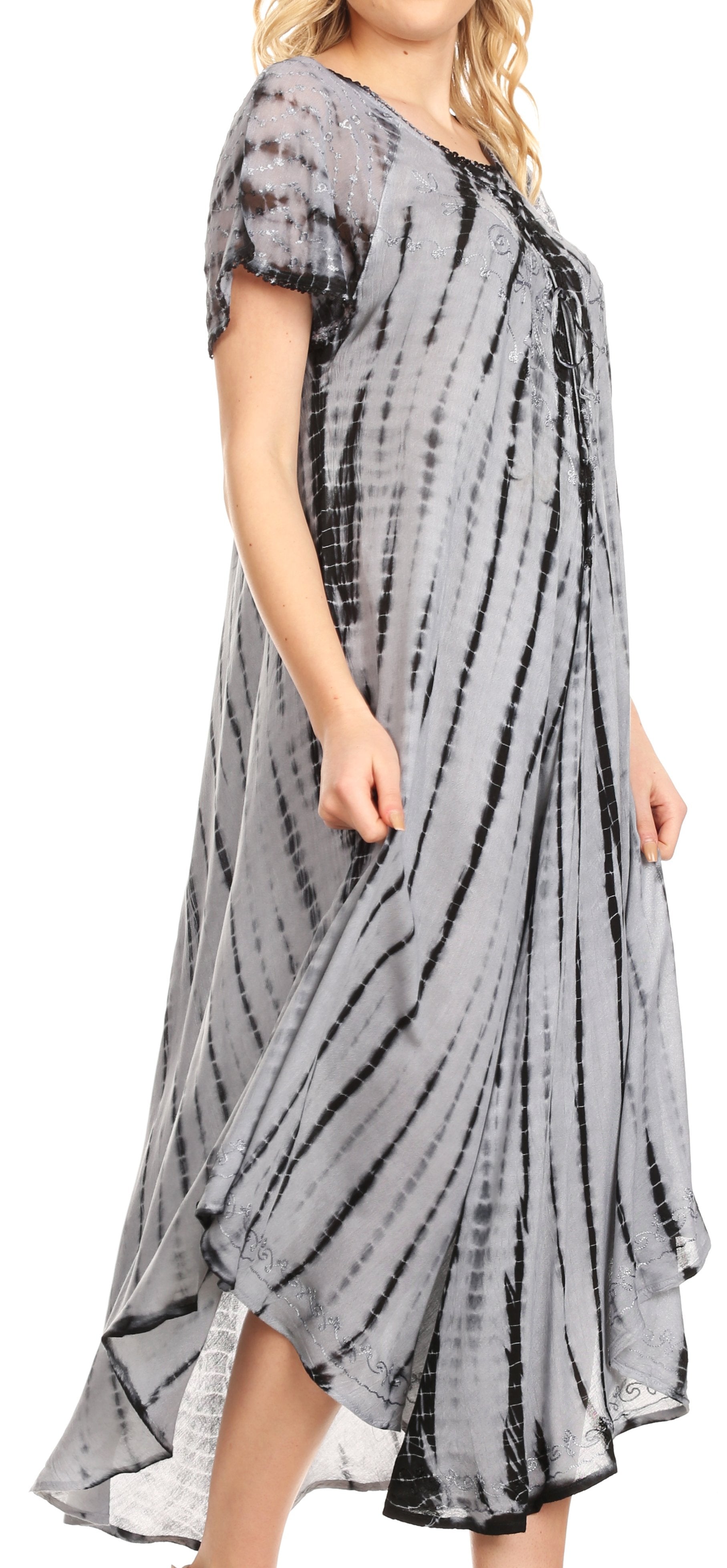 Woman wearing a gray tie-dye dress with a white background