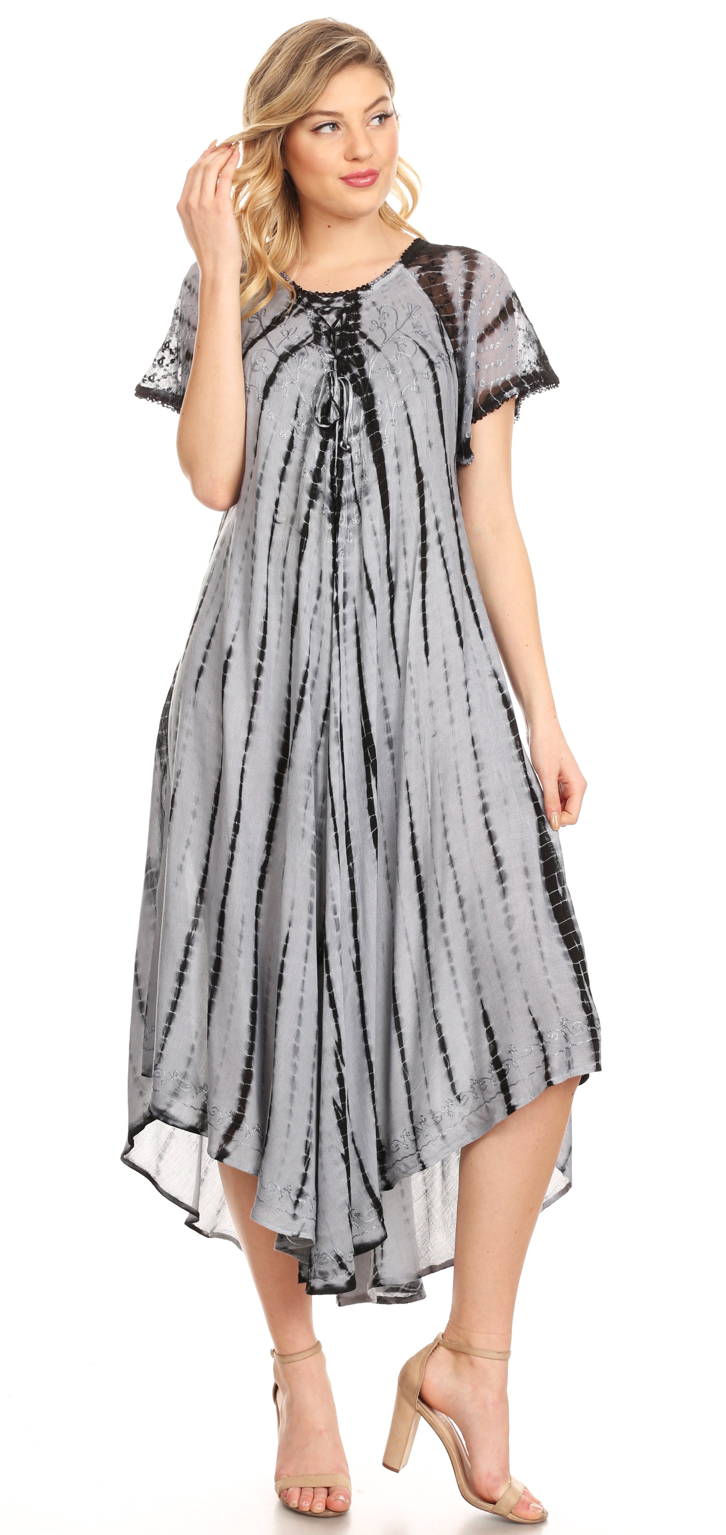 Woman wearing a gray patterned dress on a white background
