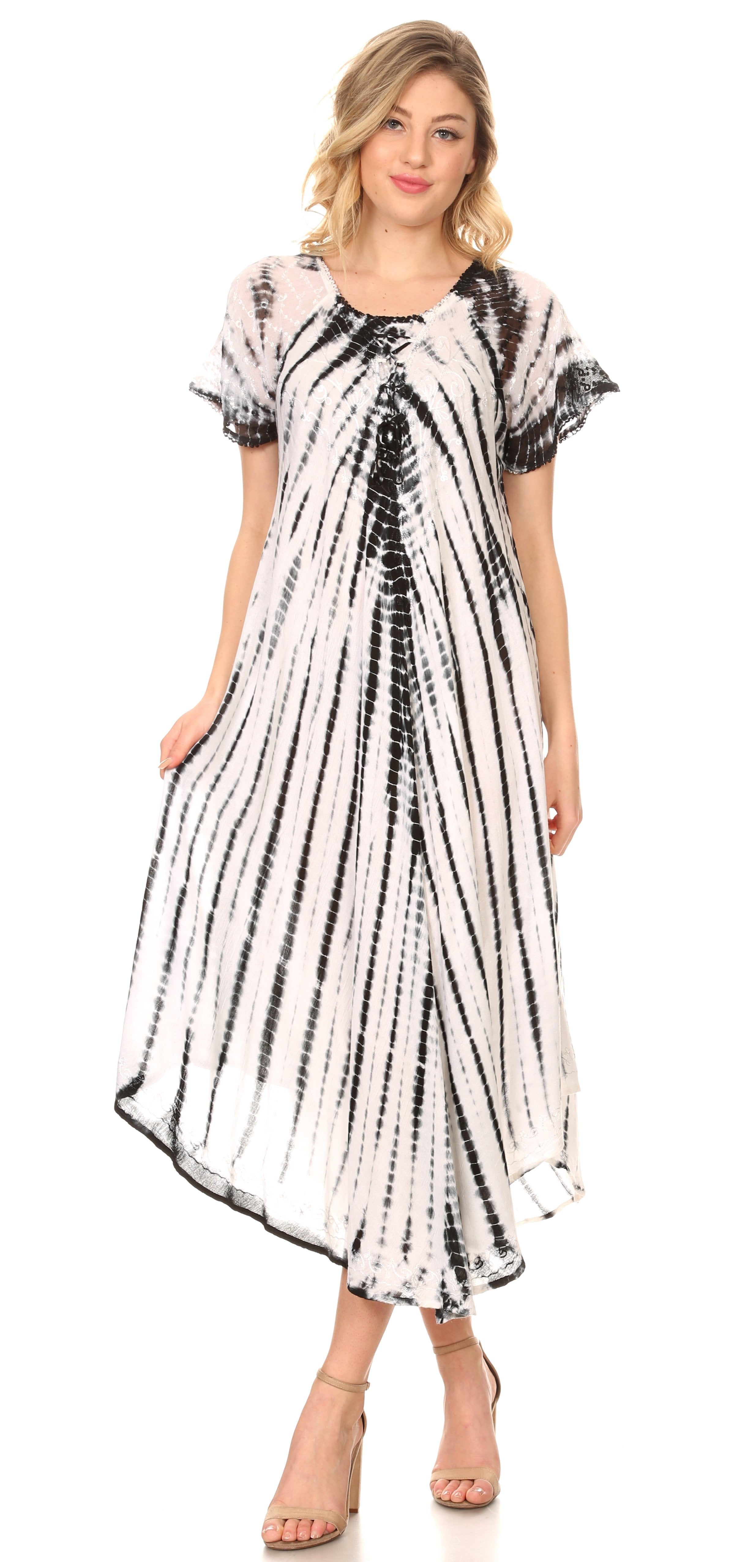 Woman wearing a black and white tie-dye dress on a white background