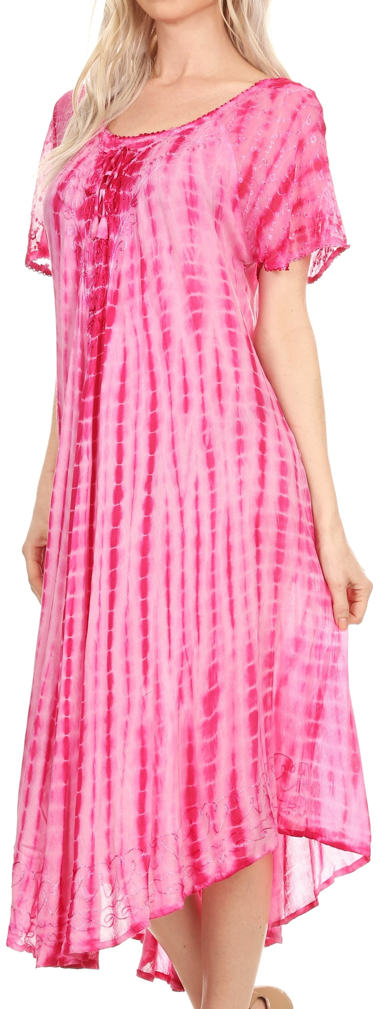 Woman wearing a pink tie-dye dress with a plain background