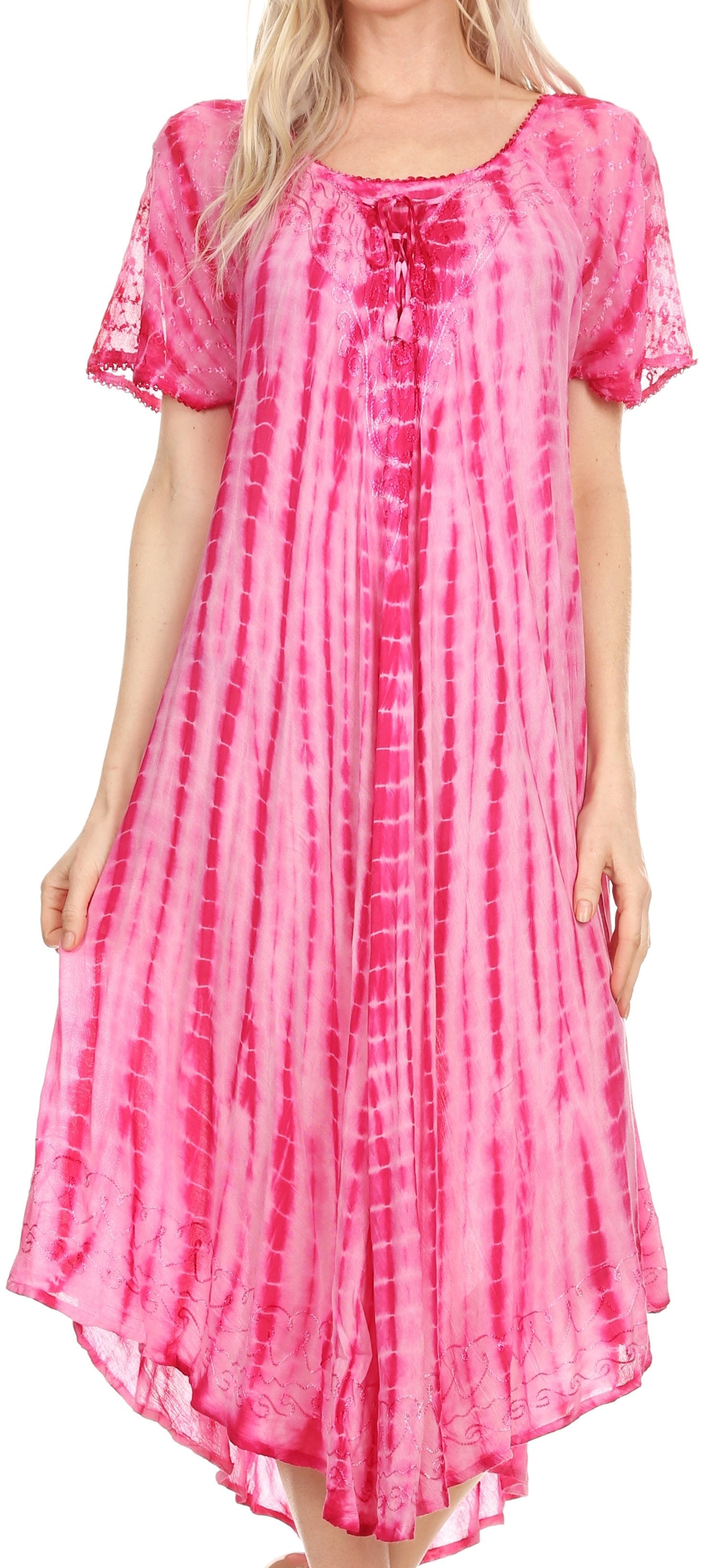 Woman wearing a pink tie-dye dress with a plain background