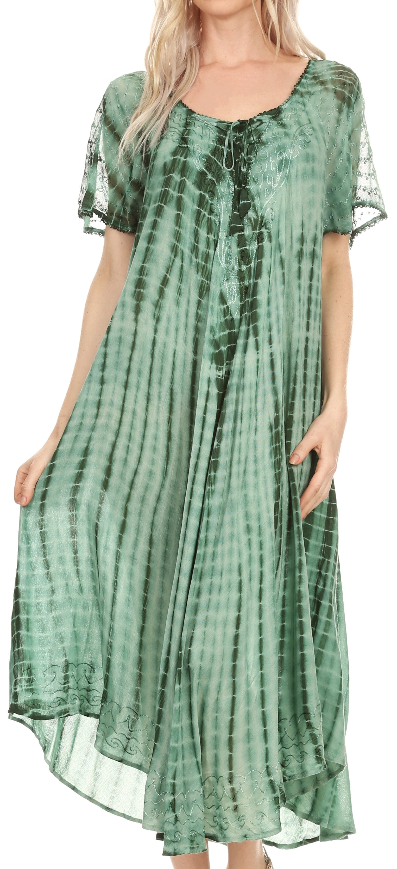 Woman wearing a green tie-dye dress with sheer sleeves.